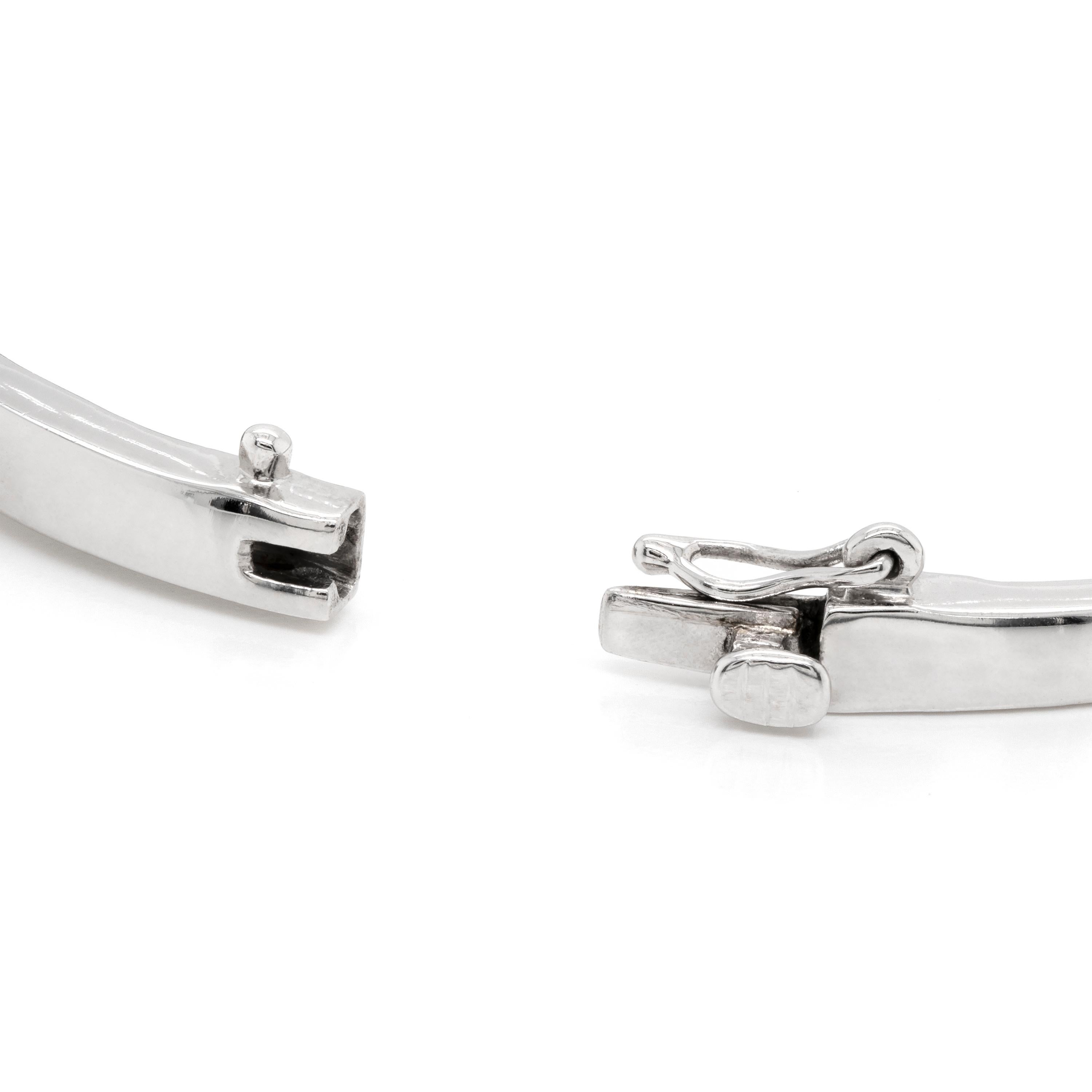 This beautiful 18 carat white gold bangle bracelet features alternating round brilliant cut diamonds and baguette cut diamonds, weighing approximately 2.00ct in total. The piece measures 7 inches in length and weights 21.35 grams. Hallmarked 750,
