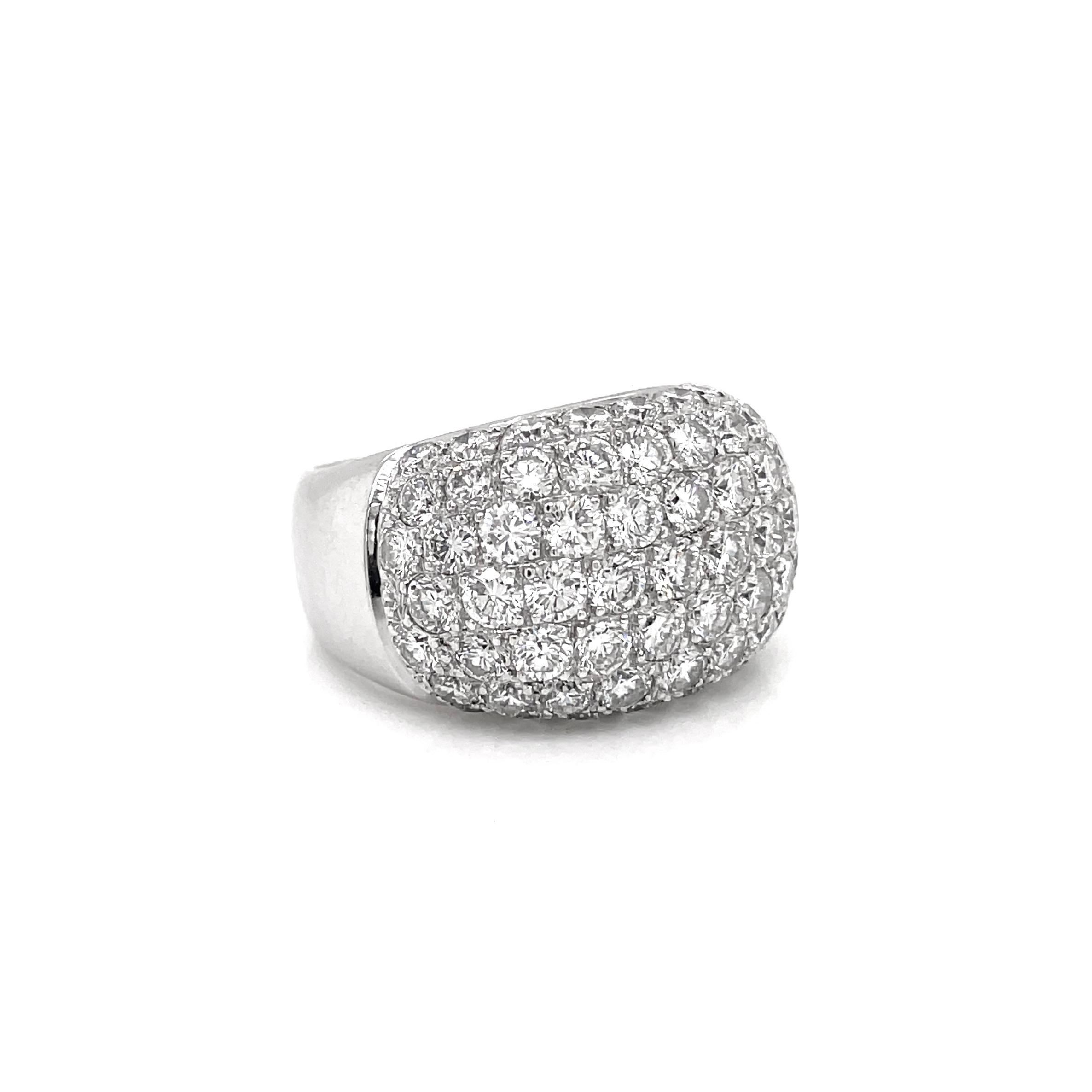 This stunning bombé cluster ring is set with 63 fine quality round brilliant cut diamonds coming to an approximate total weight of 4.50ct, all pavé set in an 18 carat white gold open back mount. The ring tapers from 6.5mm at the back to 14.3mm in