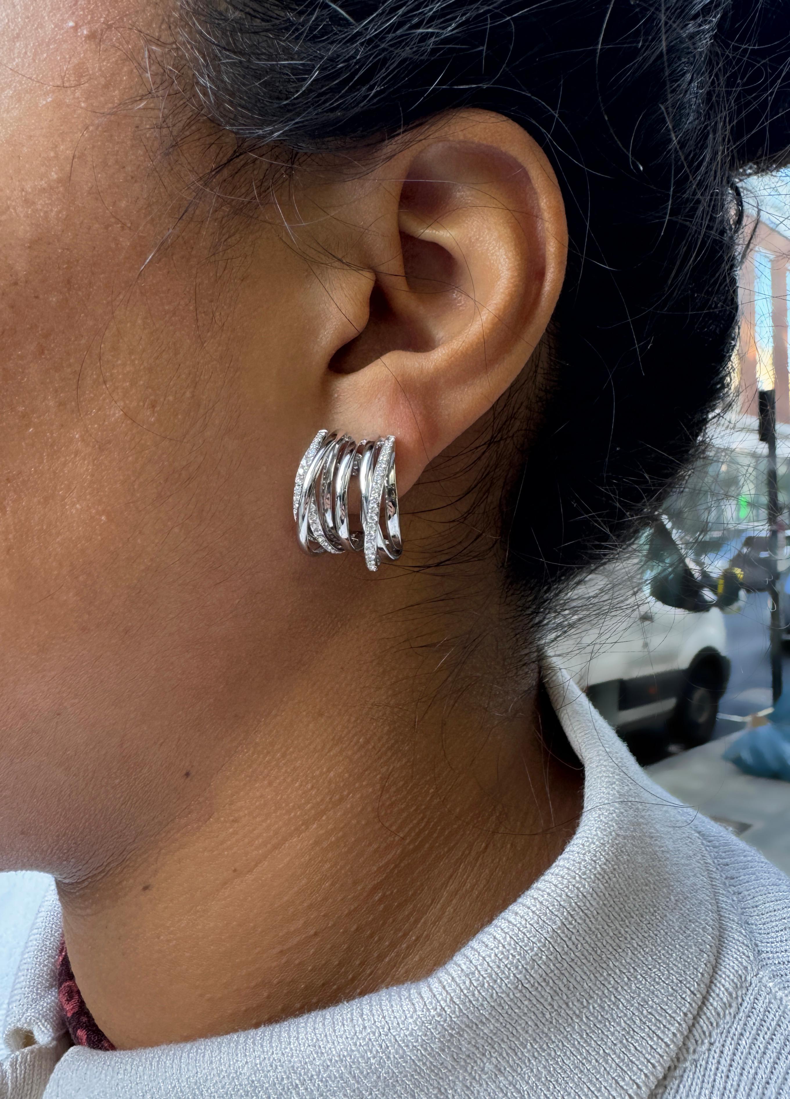 Pamper yourself with this stunning example of contemporary elegance - a wonderful pair of half-hoop earrings, masterfully crafted in luxurious 18 carat white gold.

Each earring showcases a structured open work design featuring a stunning interplay