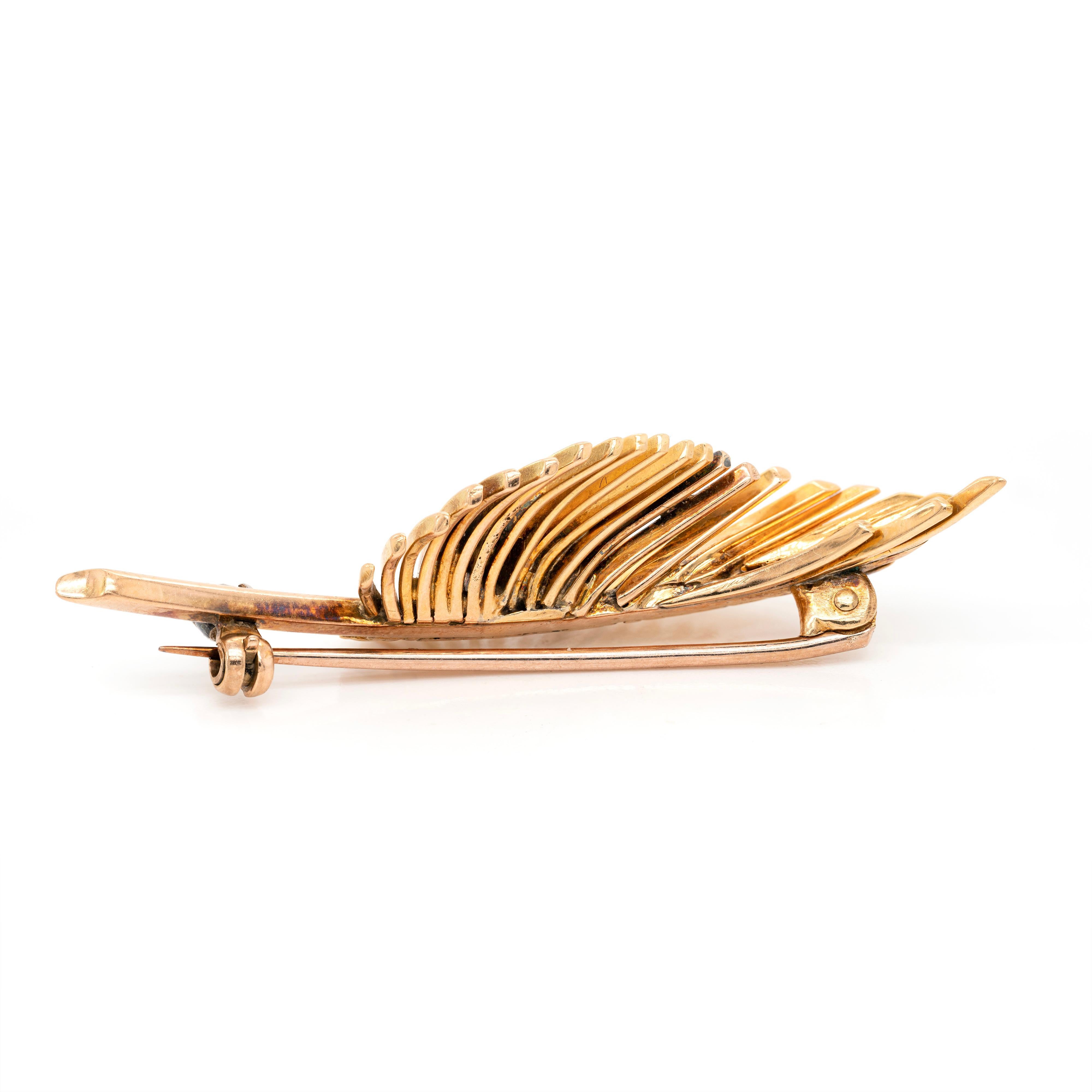 This wonderful brooch is designed as an open work leaf skeleton crafted from high polish 18 carat yellow gold. The whimsical piece is beautifully decorated with 4 round brilliant cut diamonds, weighing approximately 0.36ct combined, all mounted in