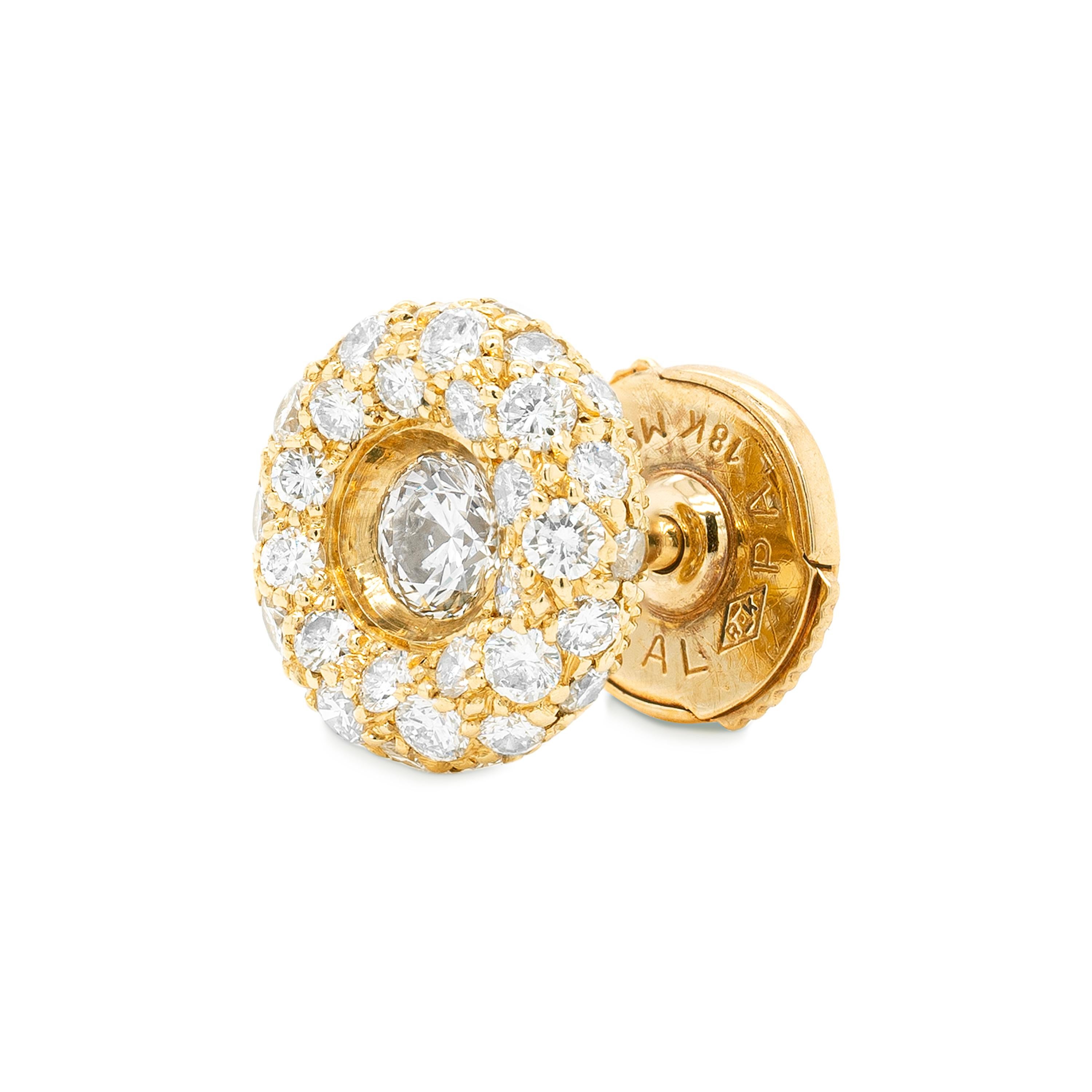 These lovely cluster stud earrings feature a beautiful round brilliant cut diamond mounted in the centre in a low rub-over setting. The centre diamond is highlighted by an 18 carat yellow gold convex border beautifully inlaid with smaller round