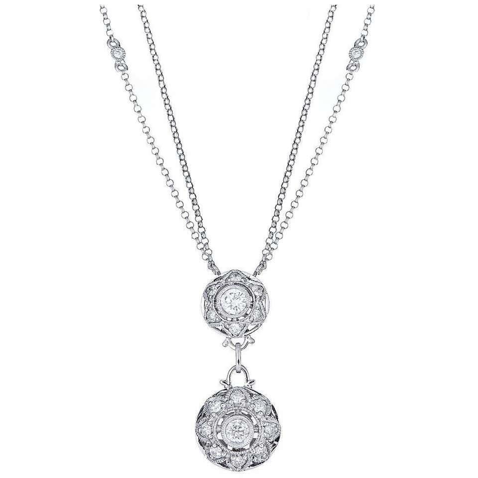 18 Karat White Gold Diamond Pendant Chain Necklace Wedding Fine Jewelry

Suspended from a double chain, this pendant necklace is fashioned in a  beautiful 18k white gold. Modern Design features round diamonds encrusted in two drop circles, creating