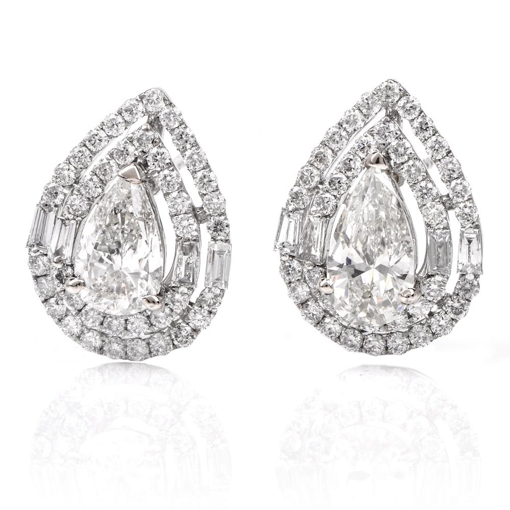 These breath taking Diamond crusted stud earrings are crafted in 18K white gold. They are centered with 2 genuine pearl shape Diamonds of approx: 1.55 carats in total, I - J color, VS1- VS2 clarity, prong set surrounded by a double halo of 80