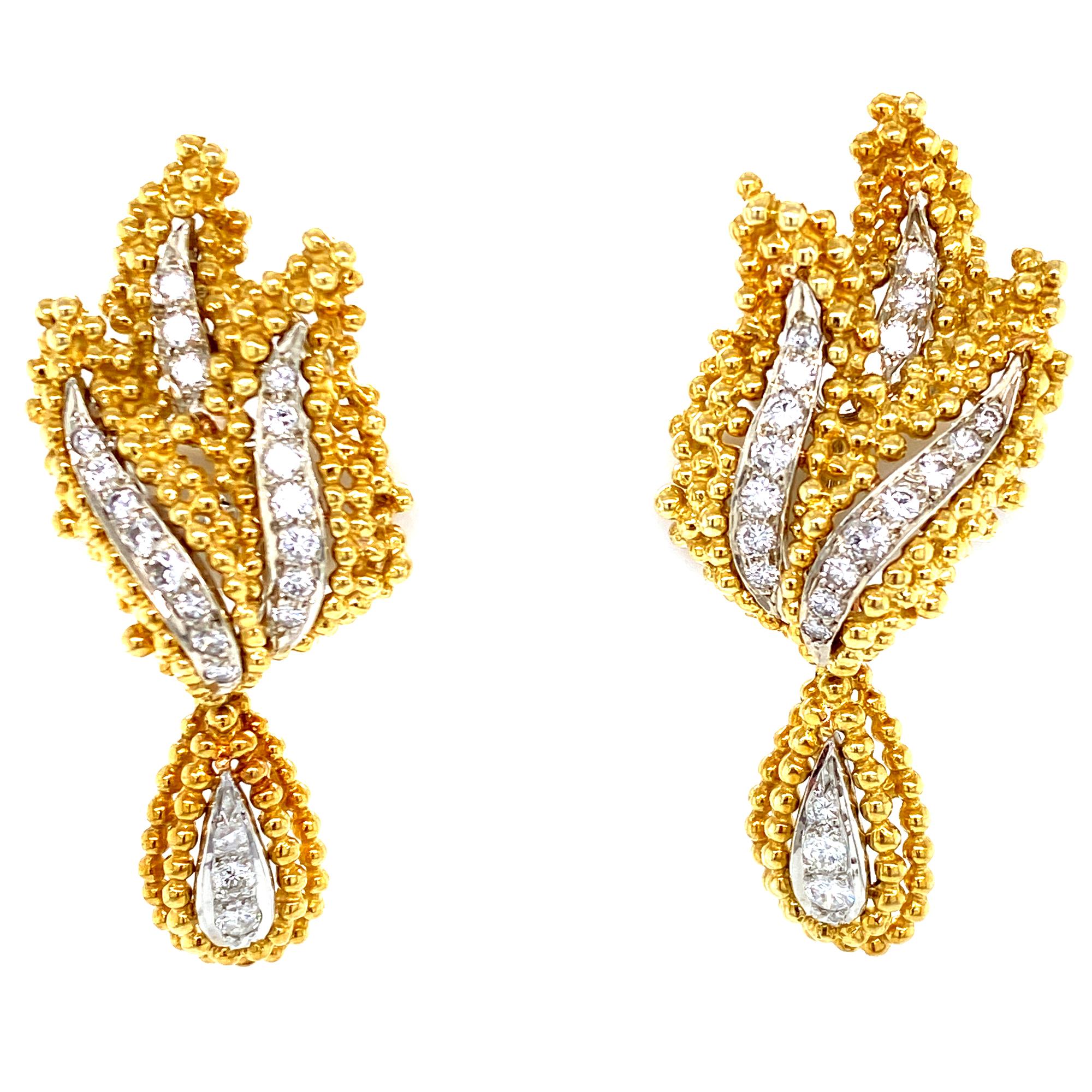 These fabulous drop leaf earrings are fashioned in 18 karat white and yellow gold. The earrings feature sparking round brilliant cut diamonds graded F-G color and VS clarity (1.00CTW). The earrings measure 2.00 inches in length,  .75 inches in
