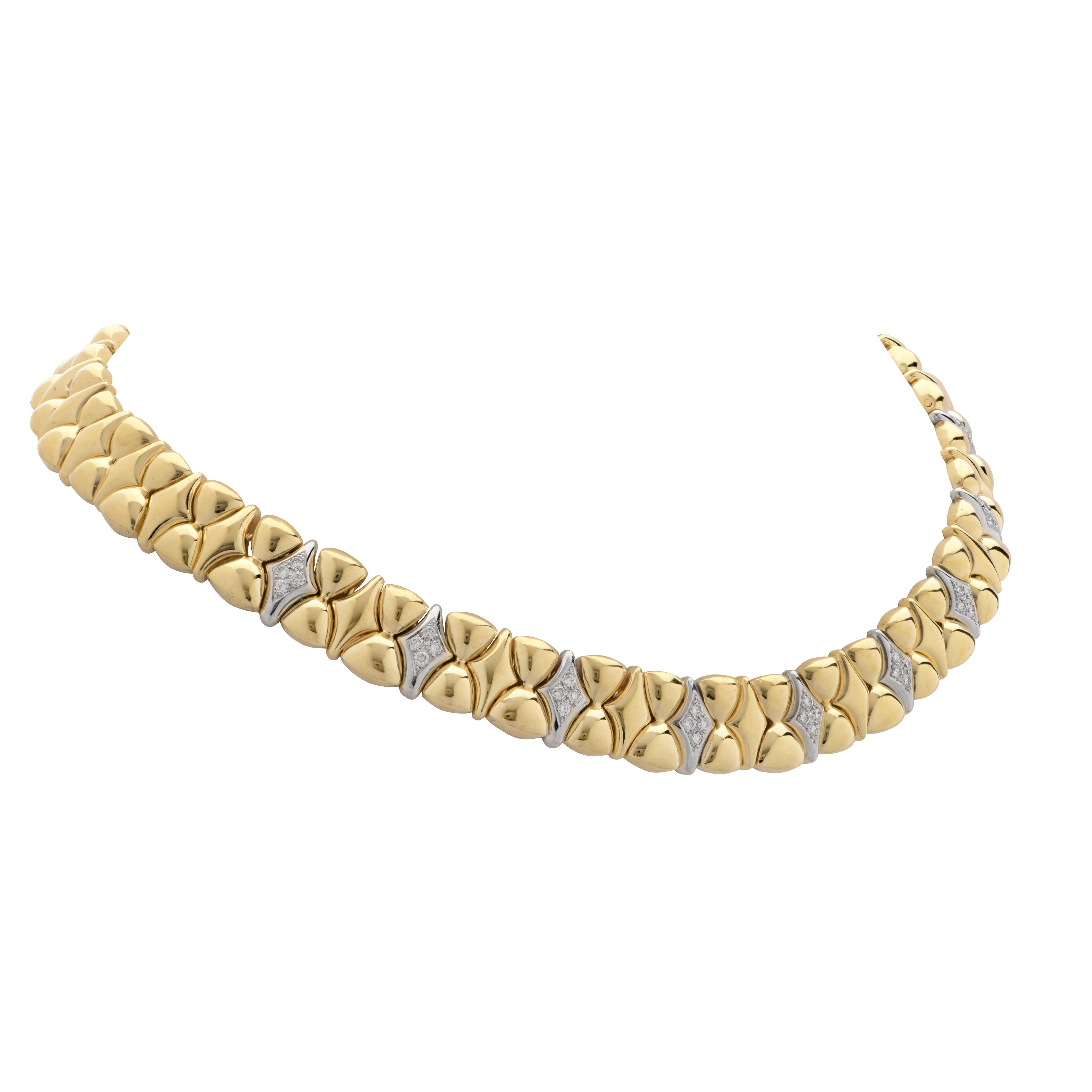 Striking necklace crafted in 18 karat yellow & white gold featuring 36 Round Brilliant cut diamonds weighing 1.25 carats, F color, VS clarity. Gold bows alternate with gold diamond shapes to create this elegant and alluring collar necklace. This