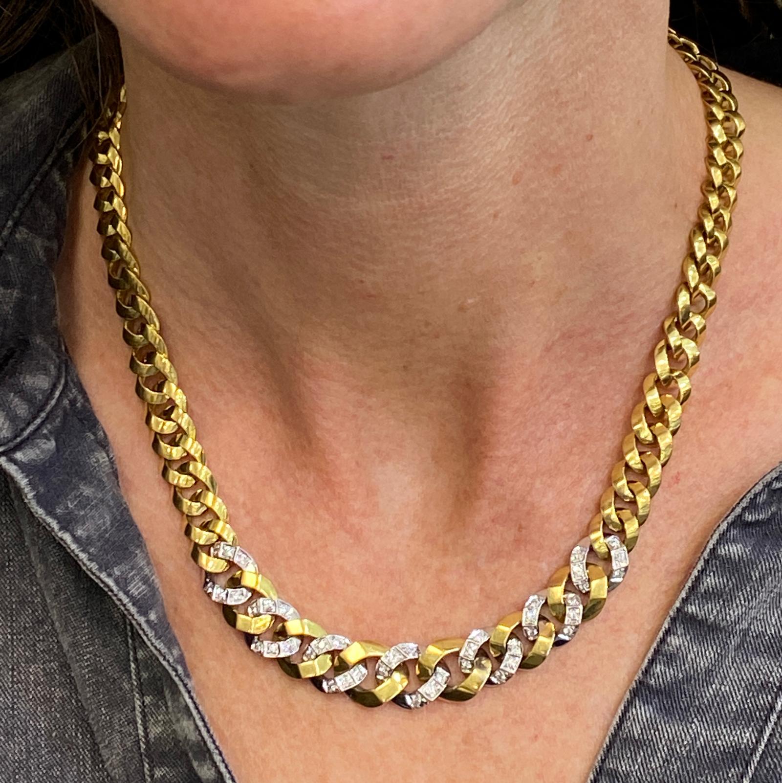 Diamond curb link necklace fashioned in 18 karat yellow and white gold. The necklace features 60 round brilliant cut diamonds weighing 1.50 carat total weight and graded H-I color and SI1 clarity. The tapered links are solid gold, and the necklace