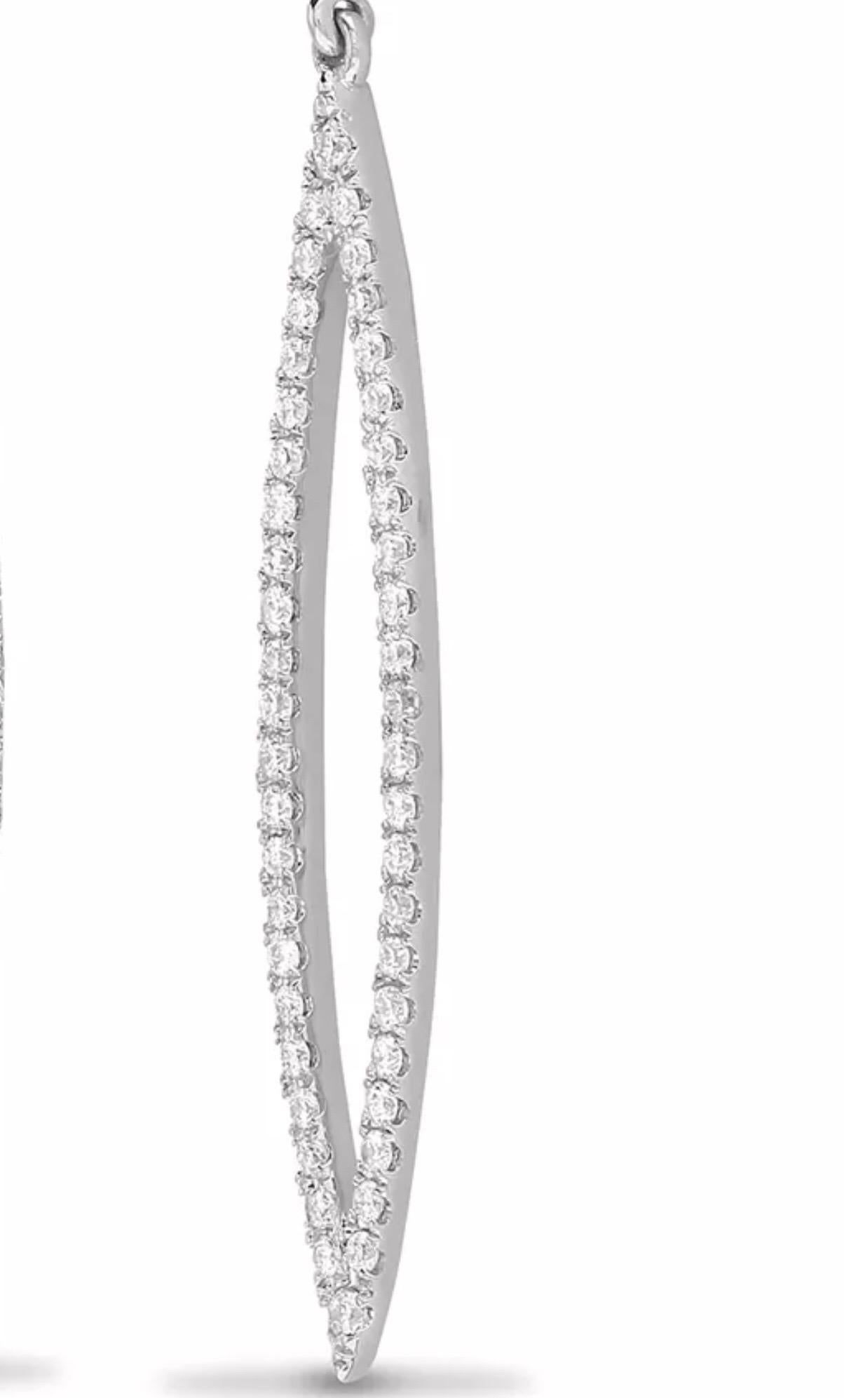 Modern Solid 18 karat white gold pave set round brilliant cut diamond drop earrings,  having 0.60 carat of white diamonds G colour and SI clarity, elegantly presented in a shooting star shape. 18 karat gold post and butterfly for ear backs. British