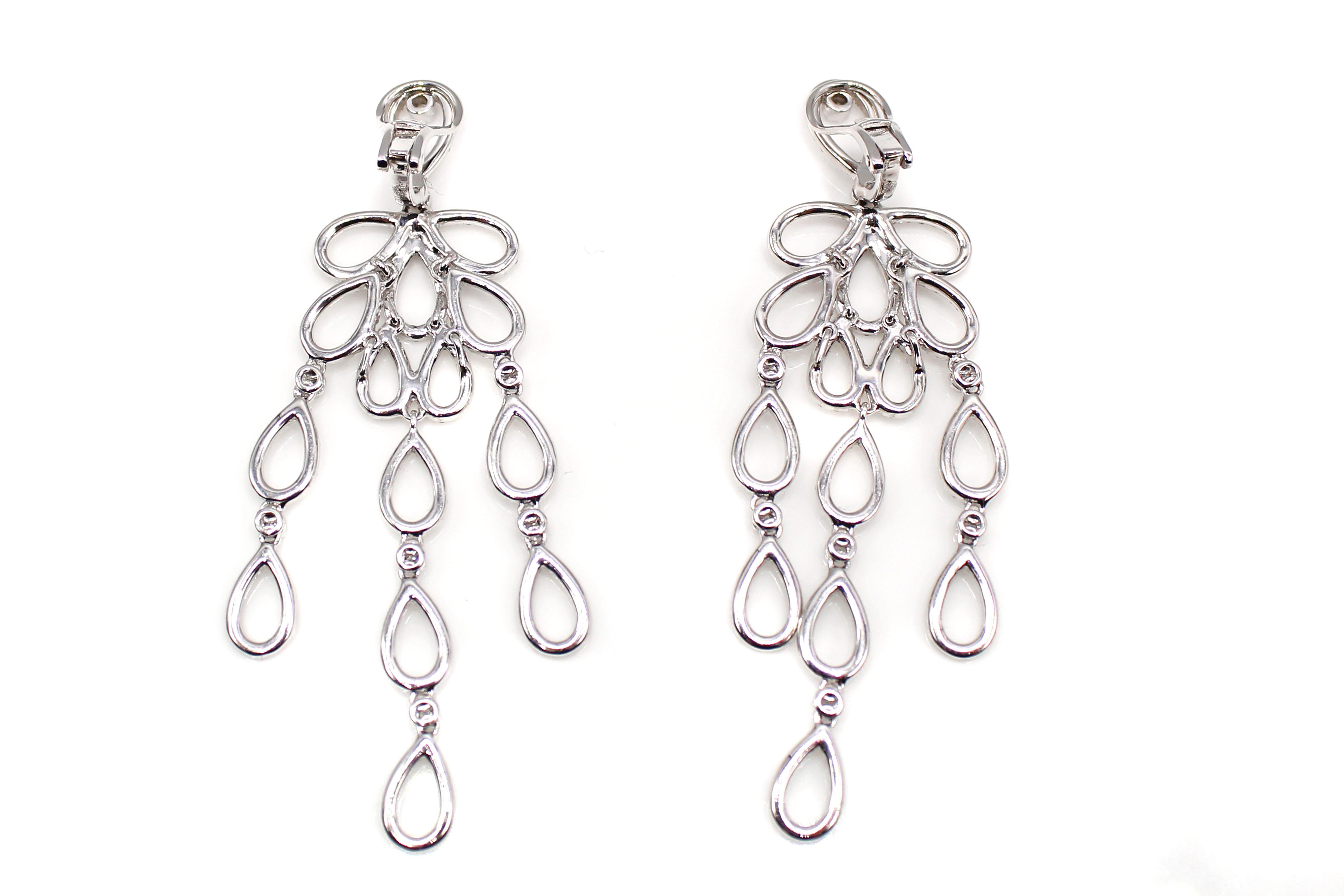 Gorgeous beautifully hand-crafted 18 karat white gold dangling earrings set with 248 bright white and sparkly round brilliant cut diamonds. The total diamond weight which is stamped on the back of the lever which connects to the omega clip back is