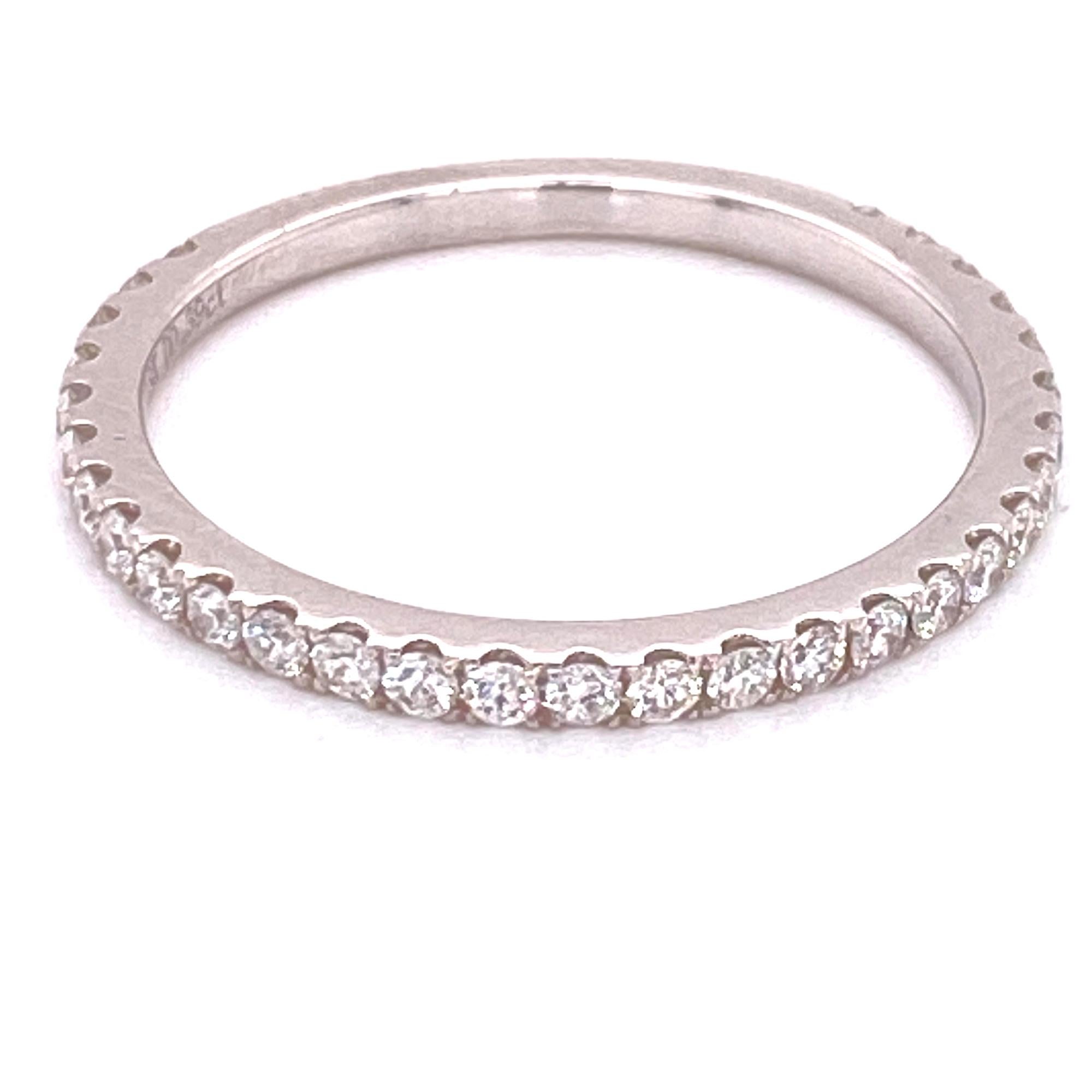 Diamond band ring fashioned in 18 karat white gold. The round brilliant cut diamonds are prong set 3/4 of the way around the band and weigh .40 carat total weight. The diamonds are graded G-H color and VS2-SI1 clarity. The thin band measures 1.5mm,