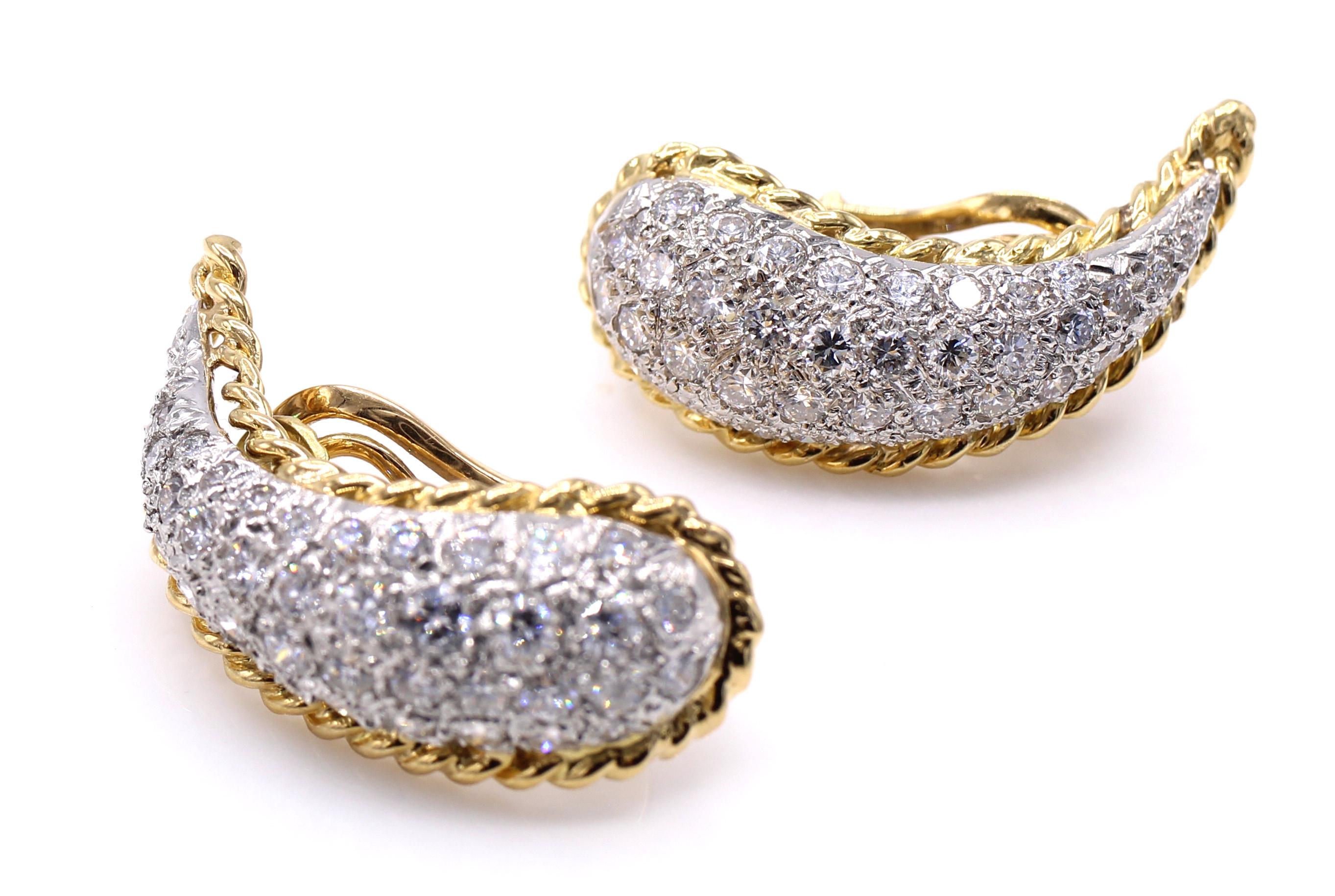 Beautifully designed and masterfully handcrafted in 18 karat white and yellow gold. The teardrop shaped ear clips embellish the earlobe following its shape up the ear. 74 bright white and sparkly round brilliant cut diamonds are pave set embellished
