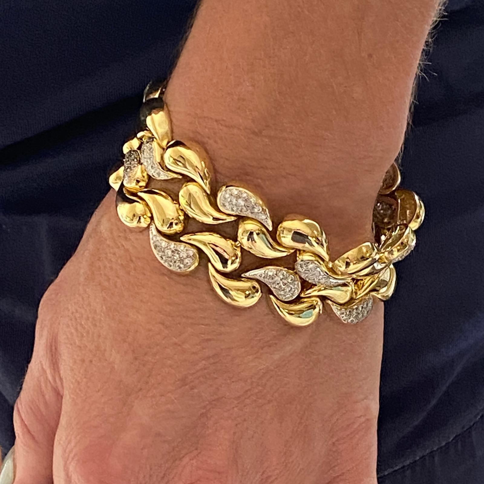 Stunning wide diamond bracelet crafted in solid 18 karat yellow gold. The infinity bracelet features 224 round brilliant cut diamonds weighing approximately 3.50 carat total weight and graded G-I  color and VS clarity. The bracelet measurs 1.0 inch