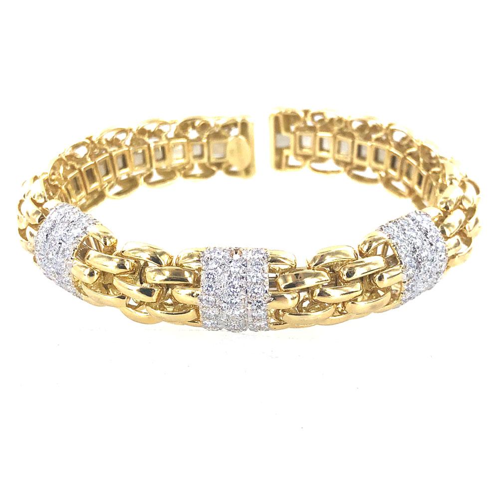 Beautifully crafted diamond bracelet fashioned in 18 karat yellow gold. The bracelet features 108 round brililant cut diamonds graded F-G color and VS clarity (3.24 carat total weight). The cuff measures 12.5mm in width and approximately 7 inches in
