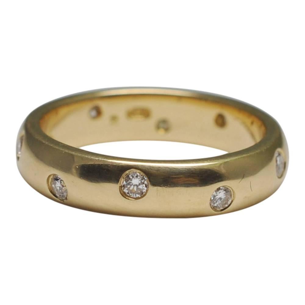 Tiffany style diamond and 18ct yellow gold wedding band; the 10 brilliant cut diamonds weigh 0.50ct and are set into the gold band; weight 6.7gms, depth of band 4.5mm; stamped 750 (18ct gold); finger size M (UK), 6.25 (US), 53 (French), 13