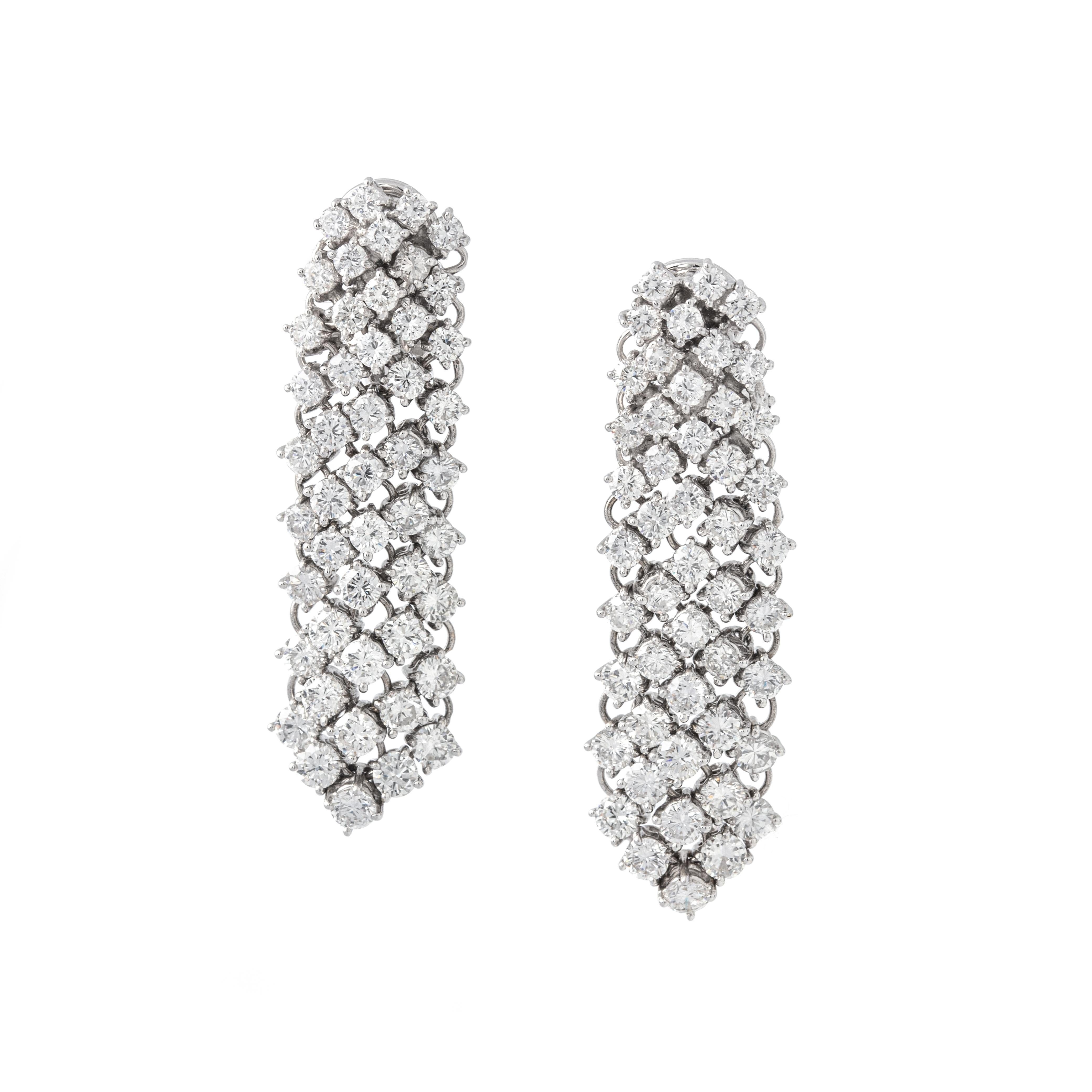 Introducing our Diamond 18K White Gold Earrings—an embodiment of opulence and sophistication.

Crafted in radiant 18K white gold, these earrings feature a dazzling array of 96 round-cut diamonds, collectively weighing 9.21 carats. The diamonds boast