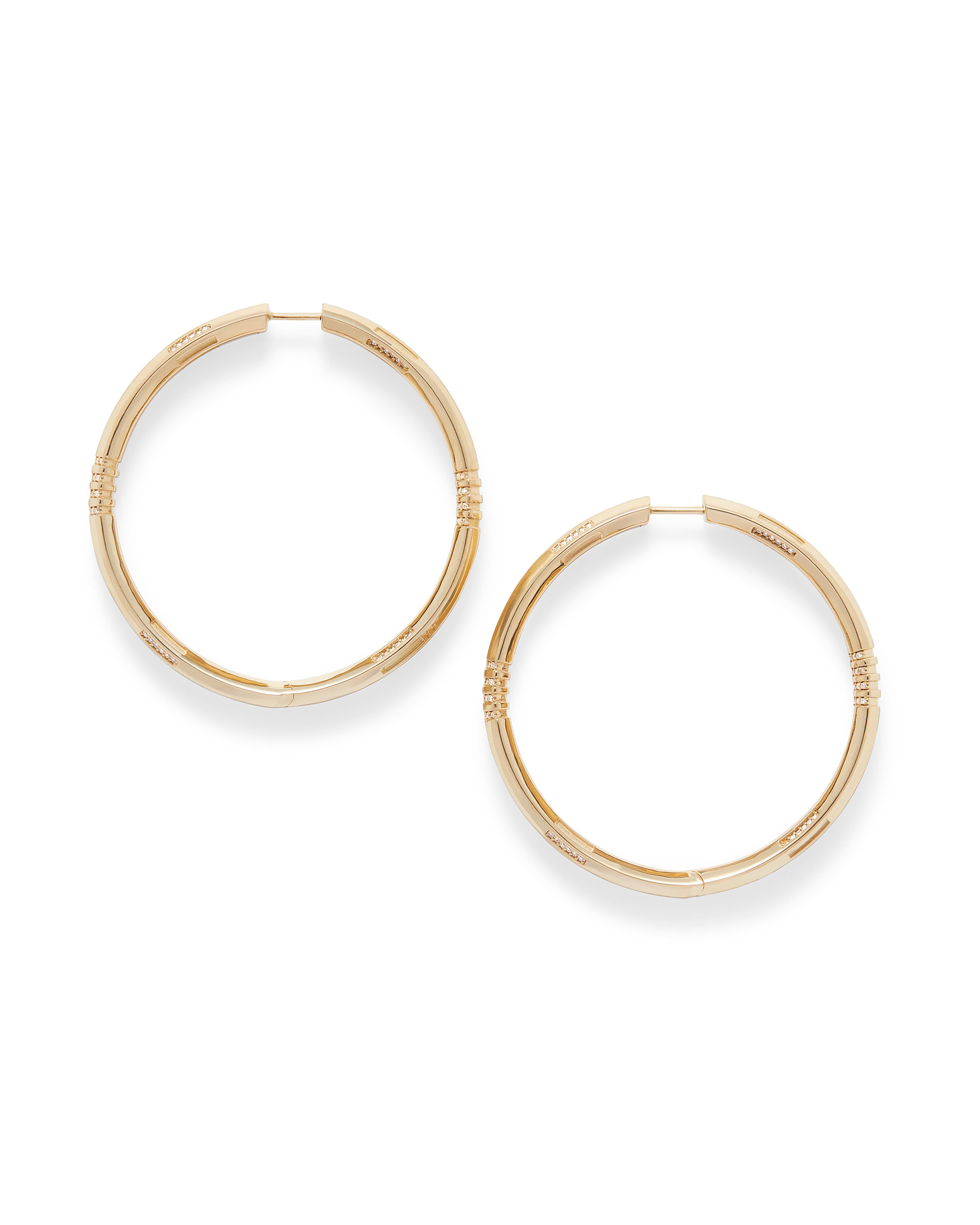 These 18K yellow gold natural diamond inside outside hoop earrings were inspired by the spindle pattern found in traditional Mudcloth textiles from the African diaspora.

Matte and high polished finishes bring dearth and dimension to these unique