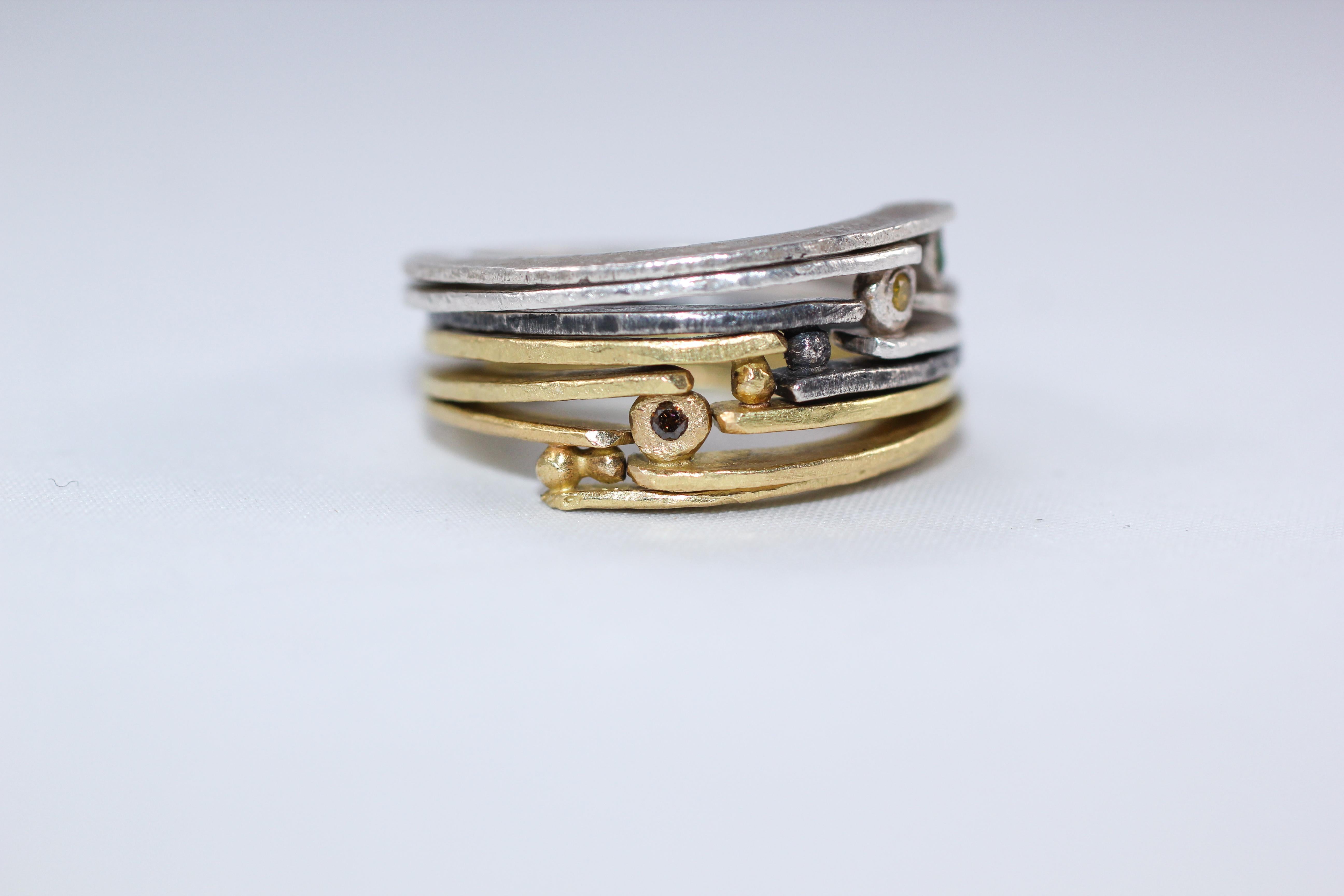 A set of six 18K gold and sterling silver fashion band rings highlighted with yellow and brown diamonds. Simplicity With A Twist design, a combination of three 18K gold and three sterling silver rings. This unisex combination would make an
