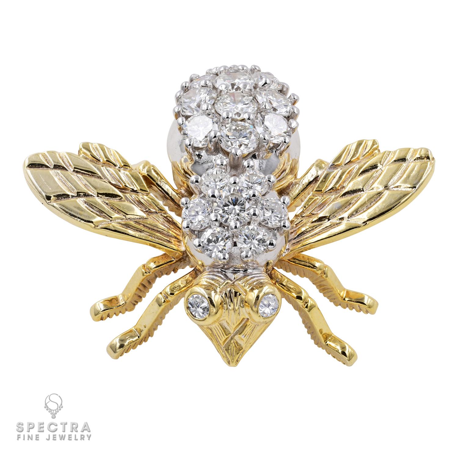 This tiny bee brooch boasts a voluptuous, glimmering belly adorned with white round brilliant diamonds, approximately F-G color, VS clarity, and flanked with intricately engraved gold wings. Two pop-eyed diamonds extend from the bee comprising the