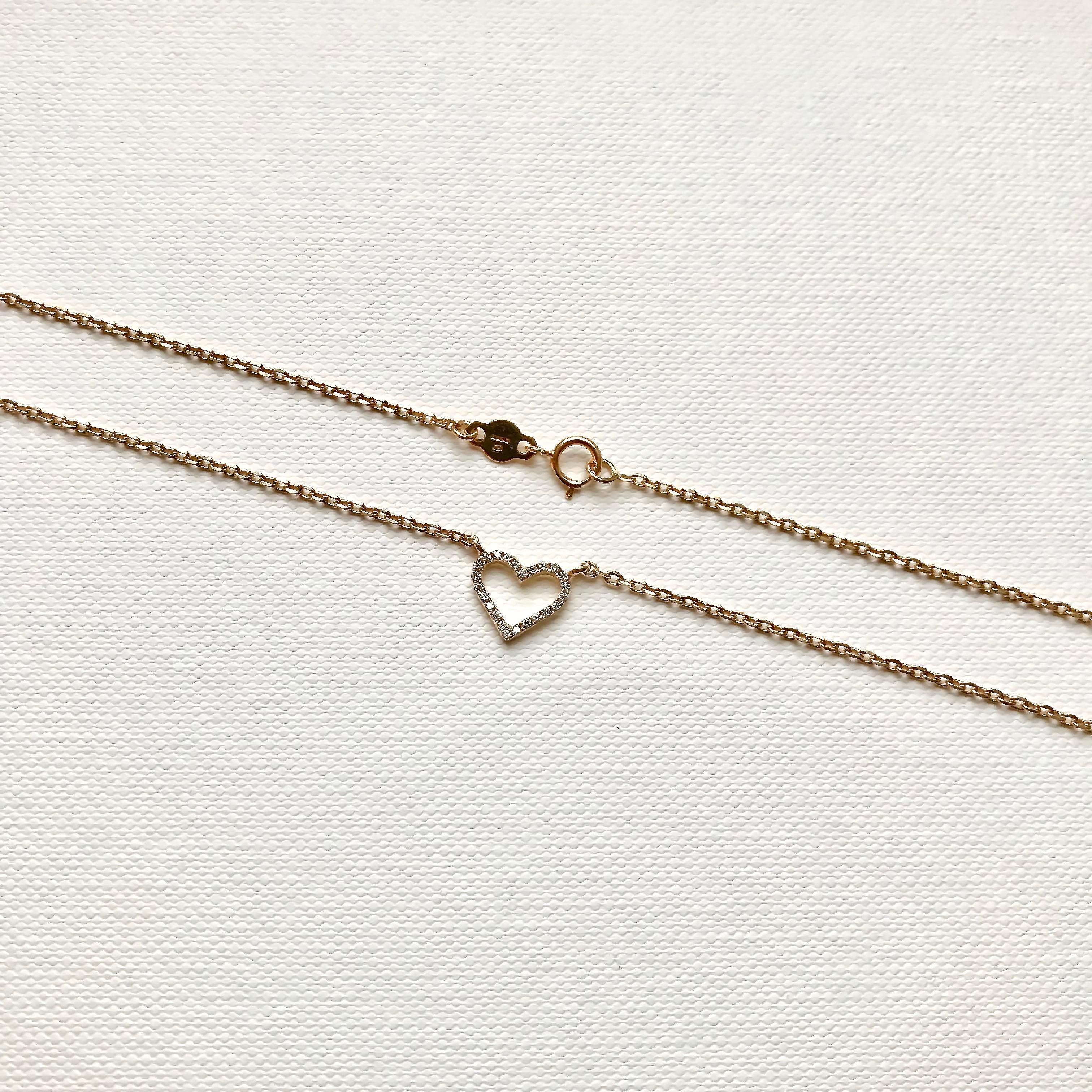 This heart necklace is made of 18Karat solid yellow gold and high-quality white diamonds. 
Beautiful to wear alone or layered with other chains and pendants.
Total Diamond Carat Weight: 0.09ct / 24 pcs
Heart's width: 9.3 mm
Hallmark: London