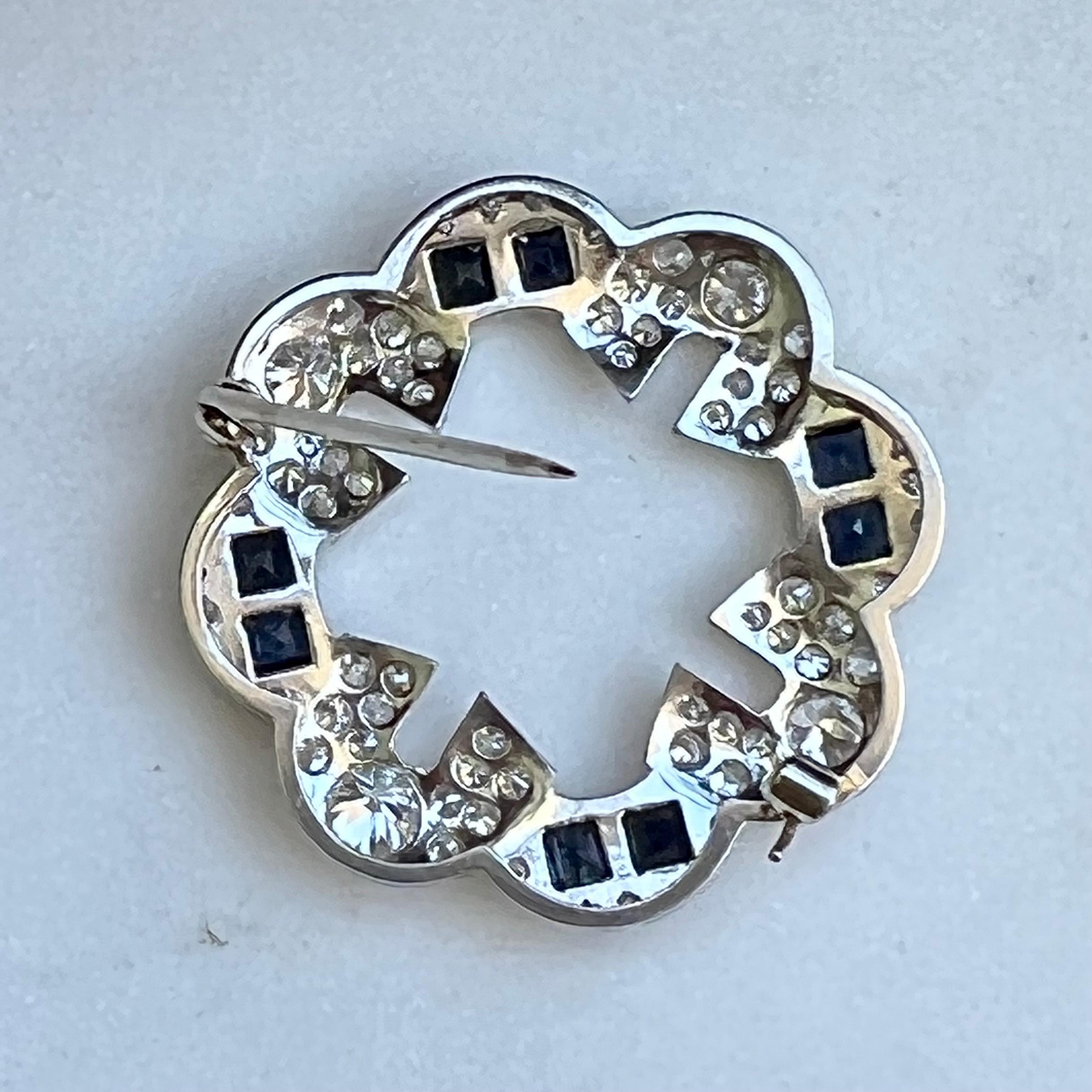 This diamond brooch is a great example of Art Deco design. The platinum setting offsets the bright white diamonds  aprox. 2.0 carats and contrast of the square cut sapphires. This is a great piece to add to you wardrobe. Maybe as the center piece on
