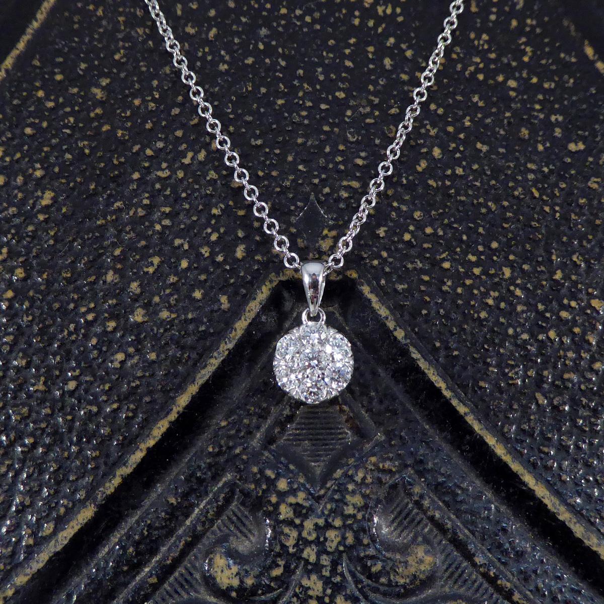 This stunning Diamond illusion cluster pendant necklace elegantly crafted in white gold, showcases a breathtaking design that gives the illusion of a single 2.00ct diamond. At its heart, the necklace features a carefully arranged cluster of diamonds