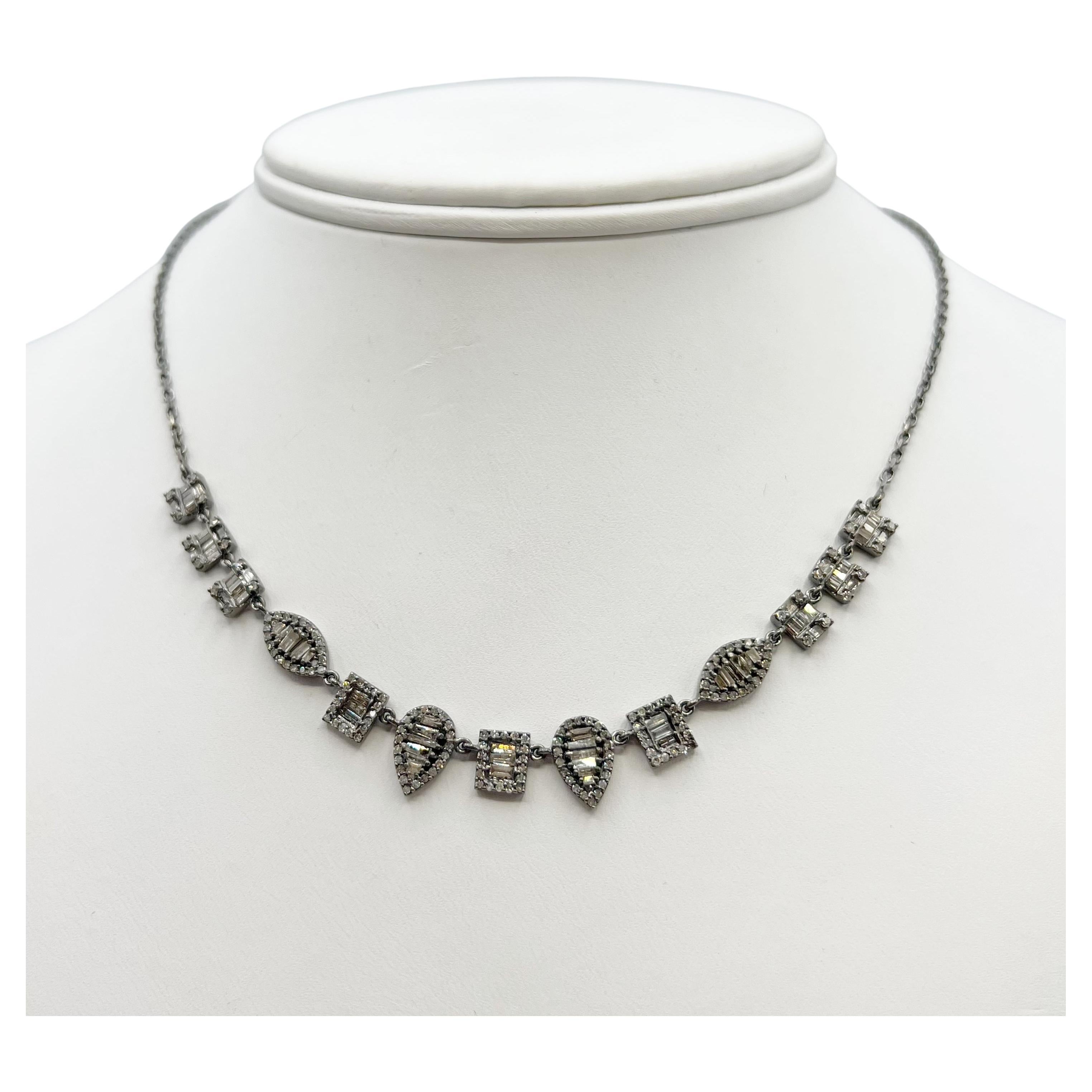 This diamond baguette Necklace is stunning. The total diamond weight is 2.11 carats set in geometric shapes strung together on a sterling silver oxidized chain. The length is 16 1/4 inches so it sits nicely on the collarbone. This necklace is modern