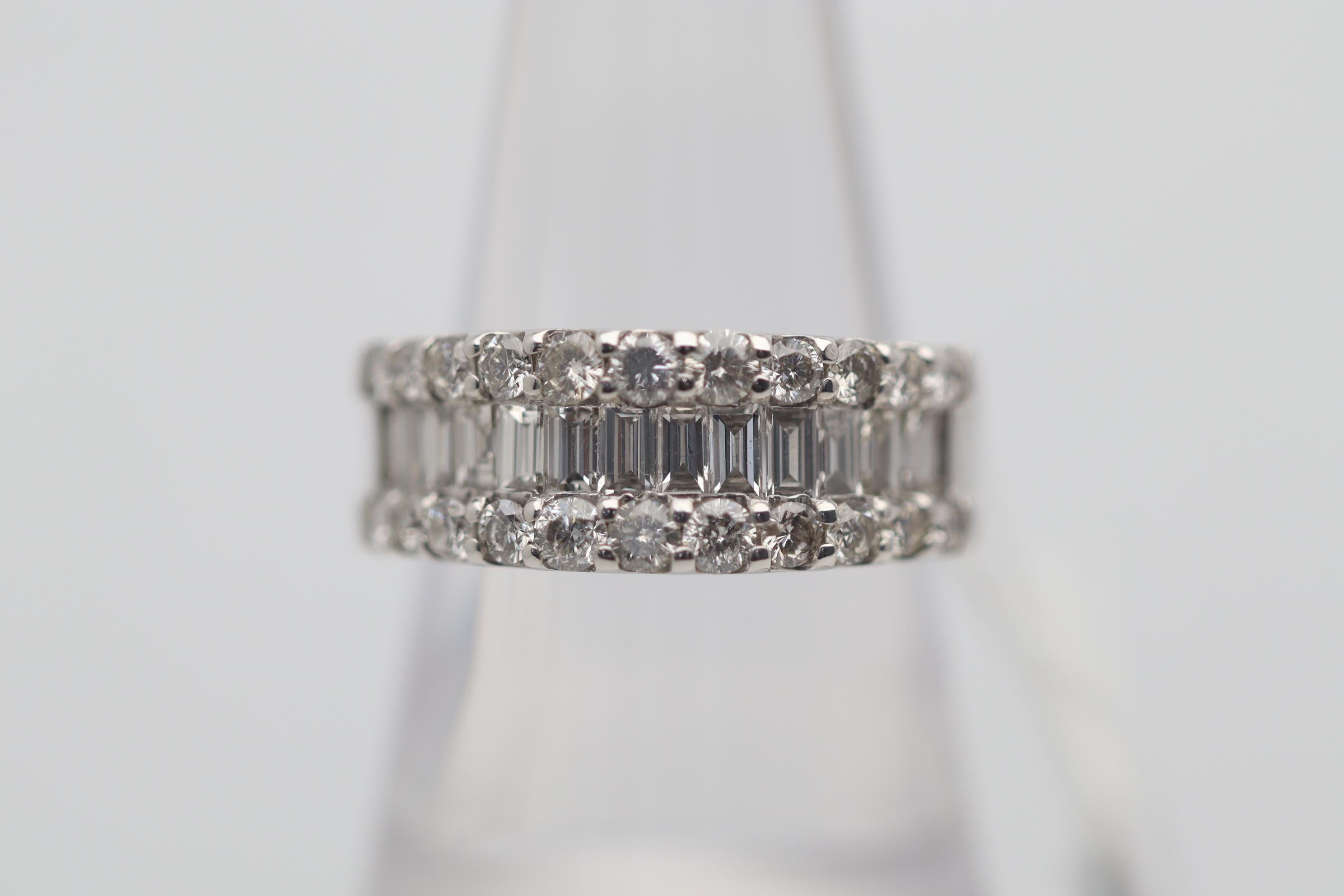 A chic and stylish platinum band featuring 3-rows of bright white diamonds. The two outer rows of diamonds are round brilliant-cuts while the center row is made of baguette-cut diamonds which are channel-set by each other. The diamonds weigh a total