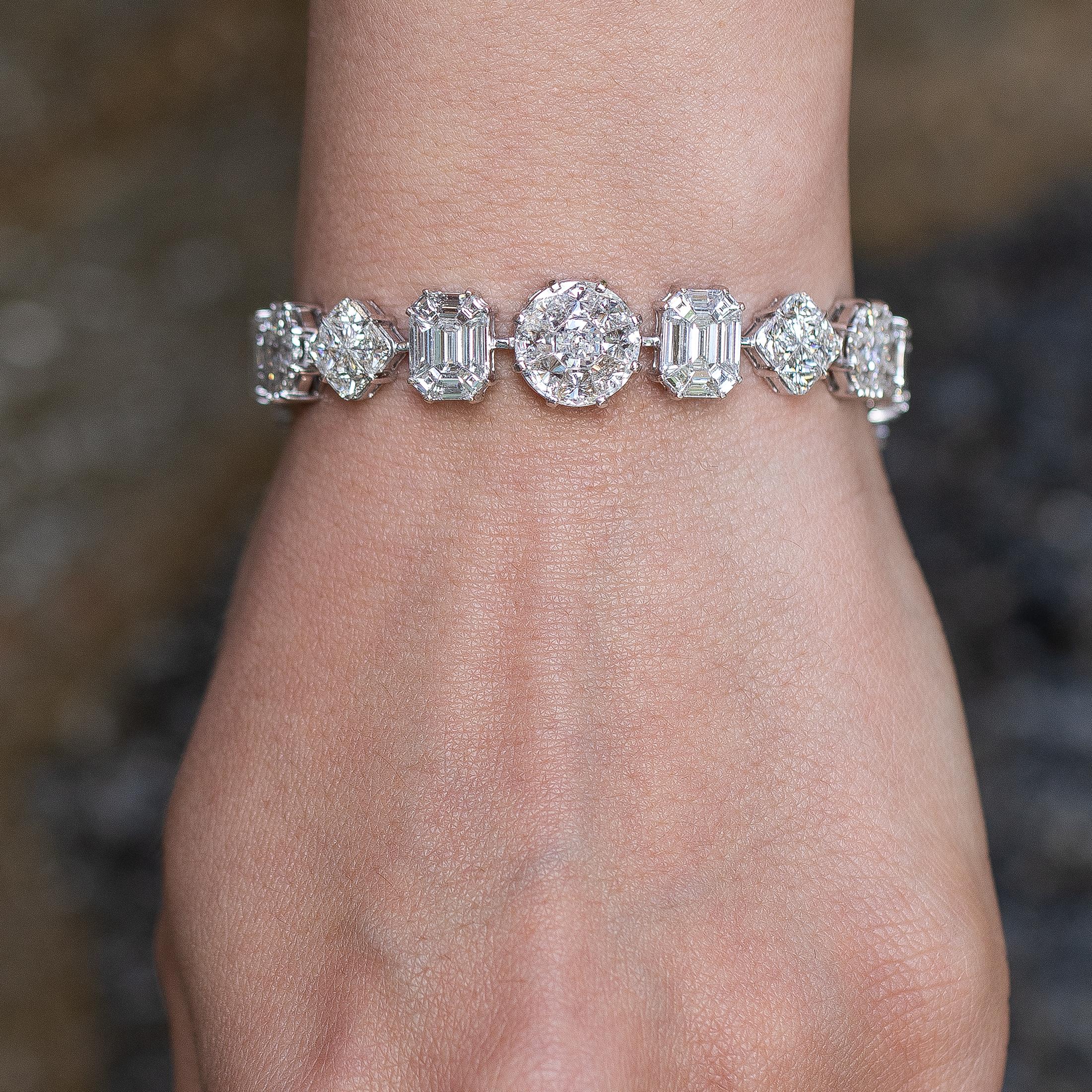 Beautiful diamond bracelet, featuring various shapes and sizes of F color diamonds. 
Diamonds = 33.75 carats
( Color: F, Clarity: VS )
18K White Gold
Length = 7 inches
Jewelry Gift Box Included