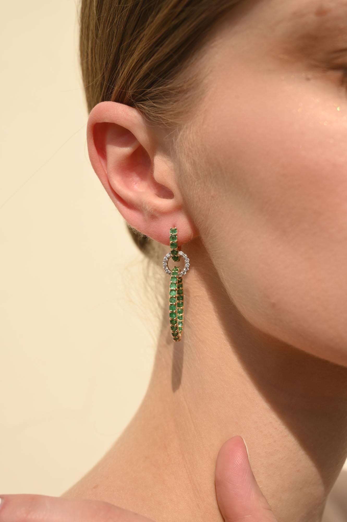 Emerald Rings Dangling Earrings in 14K Gold with Diamonds is beautifully handcrafted with love just for you. These earrings create a sparkling, luxurious look featuring 3.85 carats of round cut emerald and 0.48 carats of diamond. Pair the earrings
