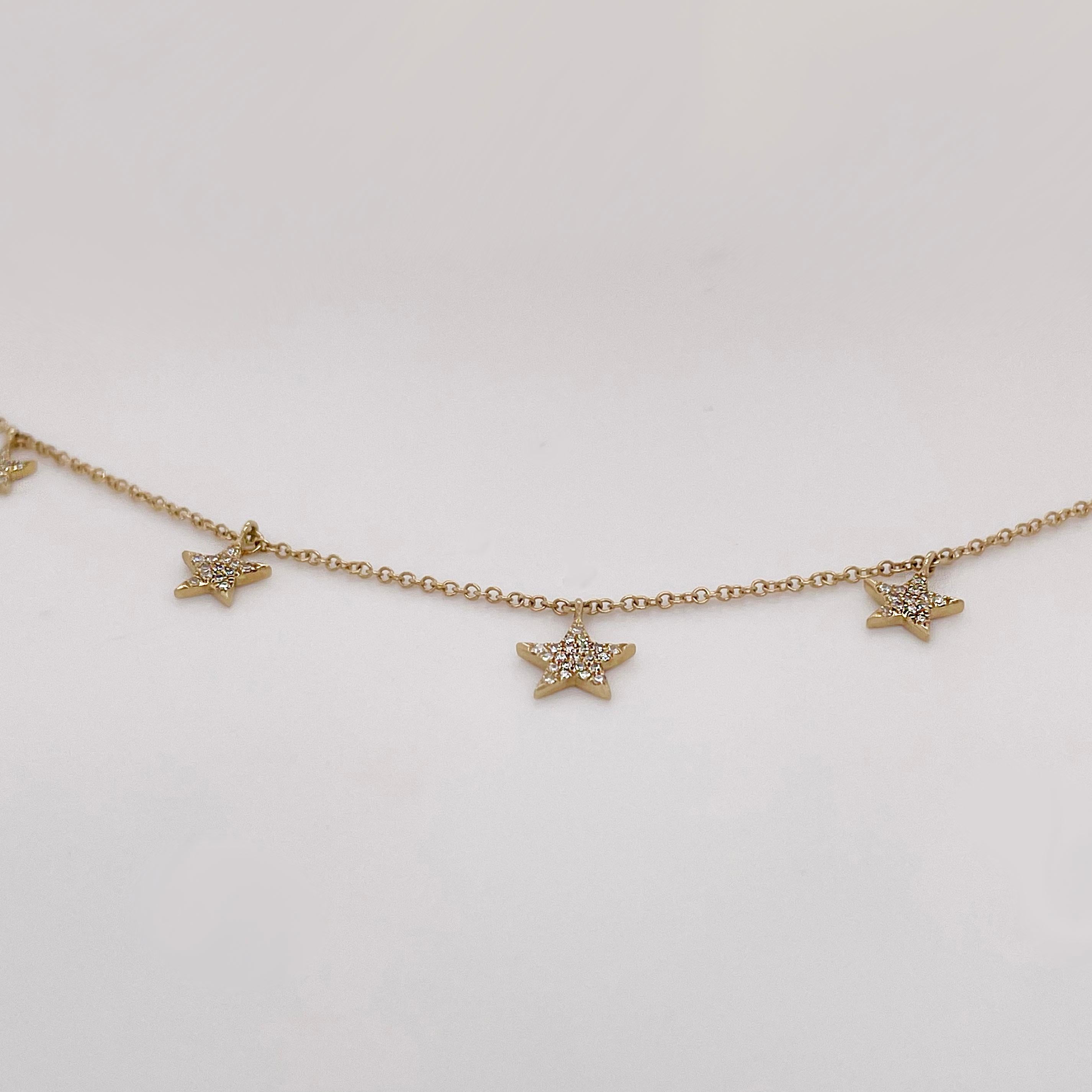 Diamond star station necklace for the diamond star in your life! This pave diamond star necklace has five star charms with round diamonds that are pave set in gold prong settings. The diamonds are excellent quality and sparkle brightly! The chain is