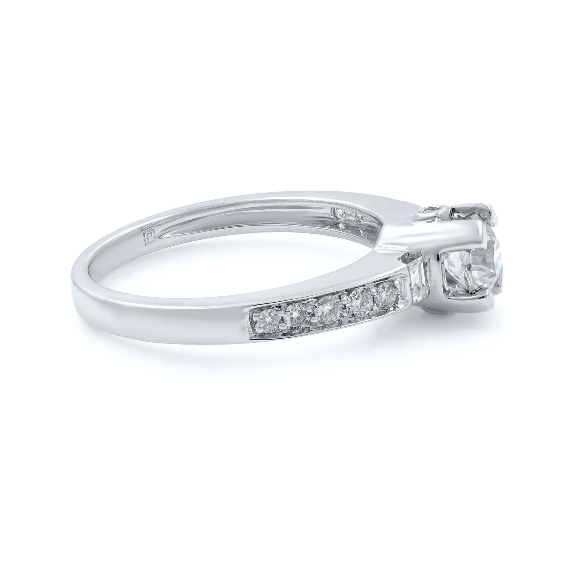 This beautiful diamond engagement ring exceptionally holds a round cut 0.55ct center diamond, which is beautifully held in a prong setting crafted in 14k white gold. Adding grace to the ring, the shank is set with tiny round cut and baguette cut