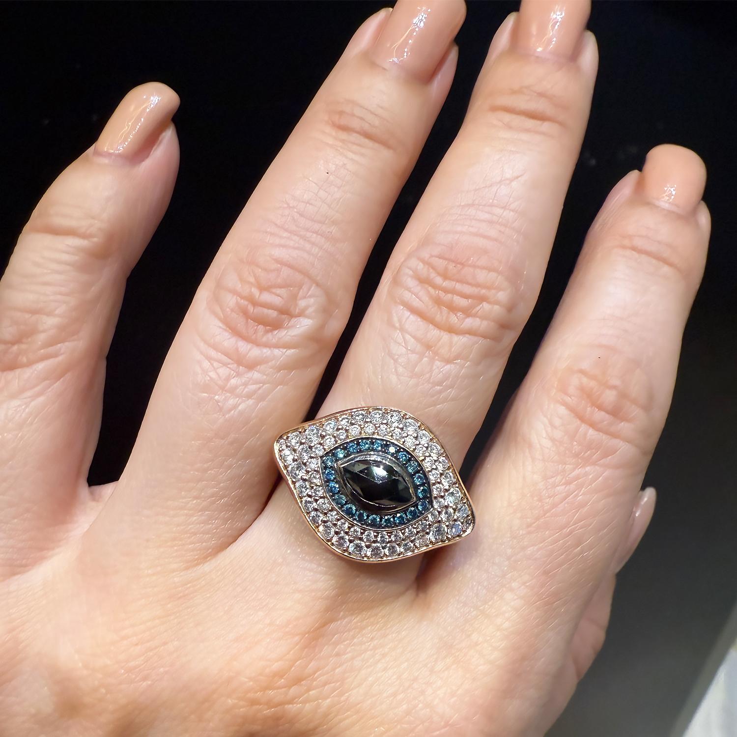 This striking Diamond “Against Evil Eye” Cocktail Ring is designed as both a powerful talisman and a captivating jewel. 
At the center rests a striking marquise-cut black diamond of approximately 1.00 carat, embodying depth and mystery. Surrounding