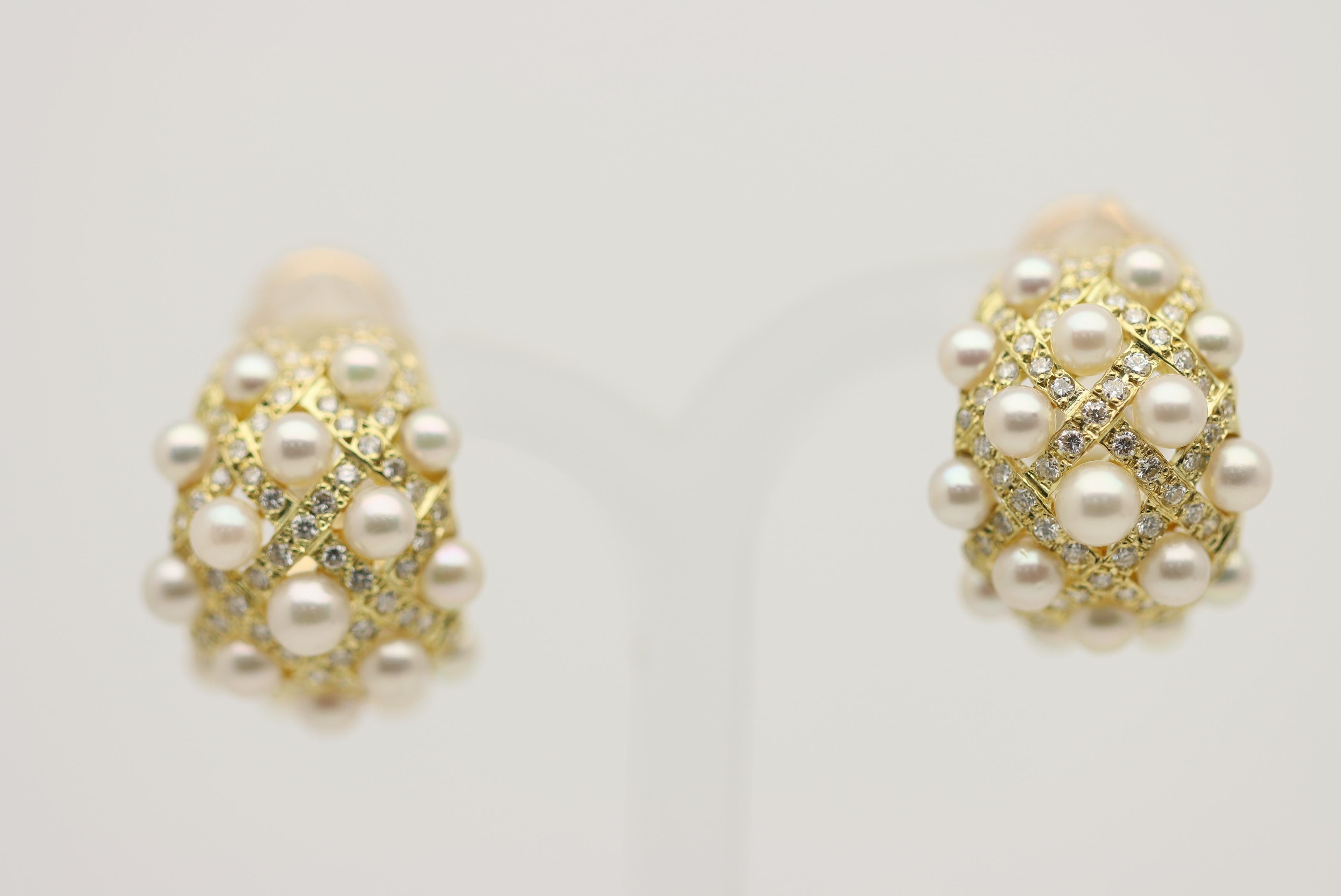 A chic and stylish pair of earrings featuring an array of fine akoya seed pearls and round brilliant-cut diamonds. The diamonds weigh a total of 1.10 carats and are set across the earrings in interesting rows. Between the openings are fine bright