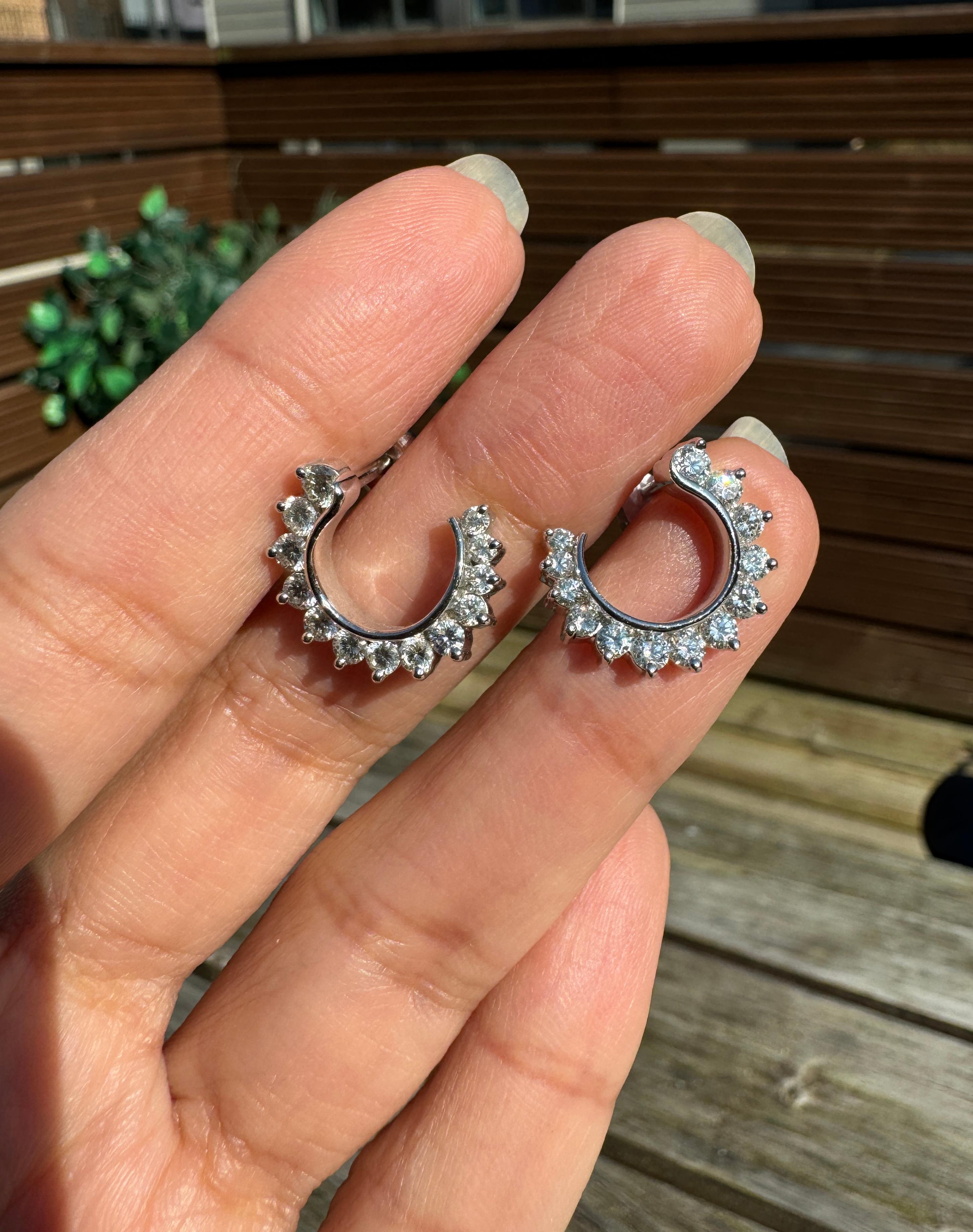 A fun yet elegant pair of gleaming 18 carat white gold stud earrings, perfect for those who love classic fine jewellery with a sophisticated twist.

Crafted with meticulous attention to detail, each earring showcases a delicate and graceful swirl