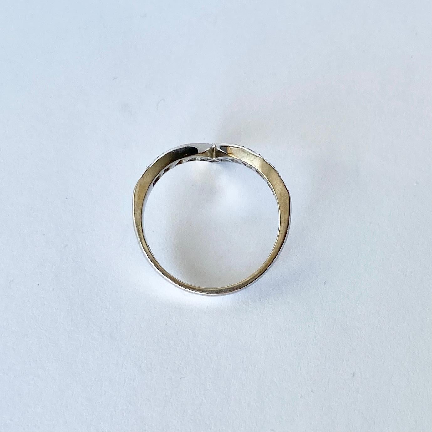 This stylish wishbone ring is modelled in 18carat white gold and holds 11 sparking diamonds totalling 35pts.

Ring Size: O 1/2 or 7 1/2 
Band Width: 2.5mm

Weight: 3.7g
