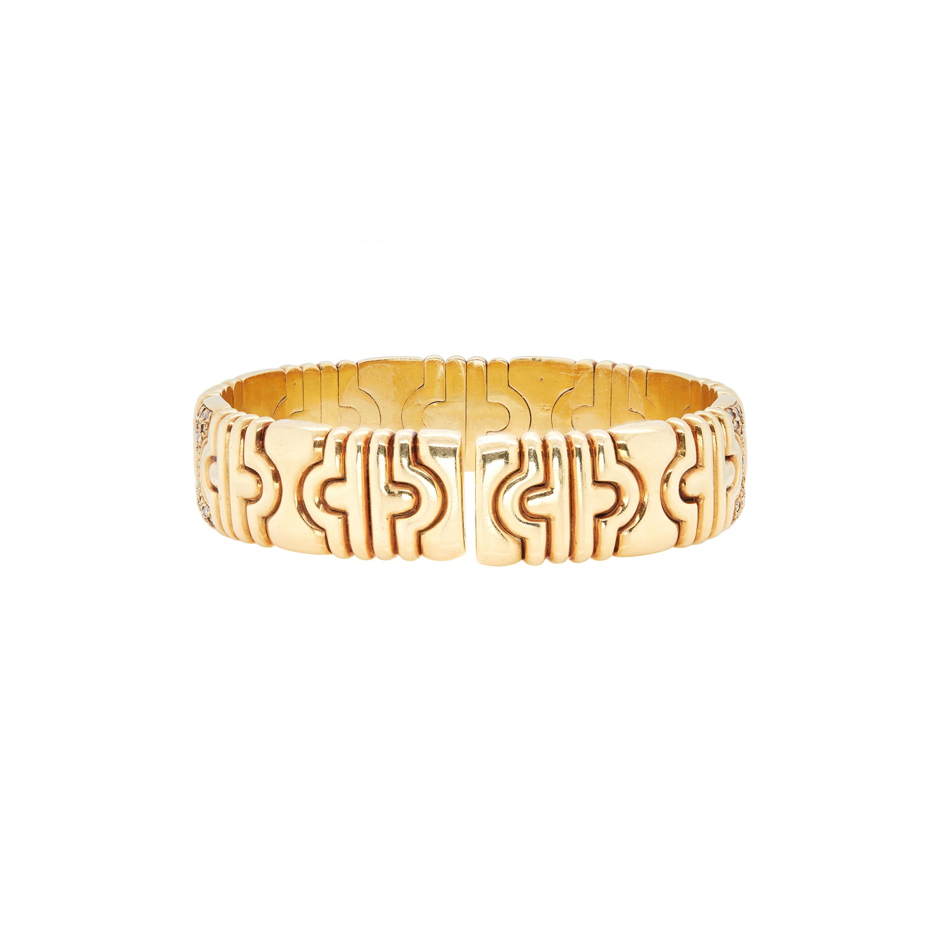 Ce bracelet exquis est un véritable chef-d'œuvre artistique, méticuleusement réalisé en or jaune 18 carats.

Le corps du bracelet est composé de maillons géométriques imbriqués et polis qui alternent avec des maillons stylisés et sertis de diamants