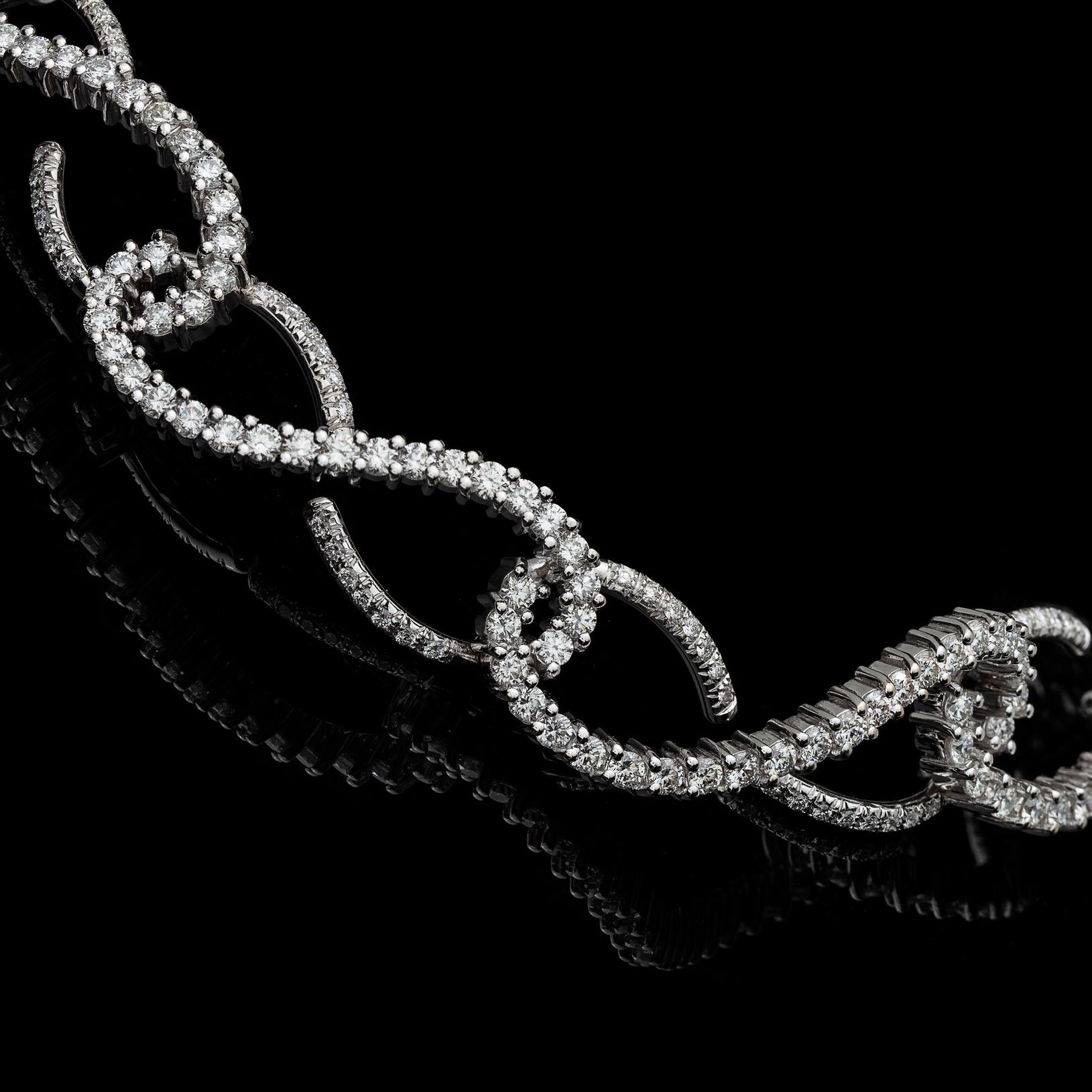 Diamonds are forever! This choker-necklace is designed with diamond-set links symbolizing eternity, featuring round brilliant-cut diamonds weighing in total approximately 7.84cts. The necklace weighs 62.2 grams, and is 14 inches long. A statement