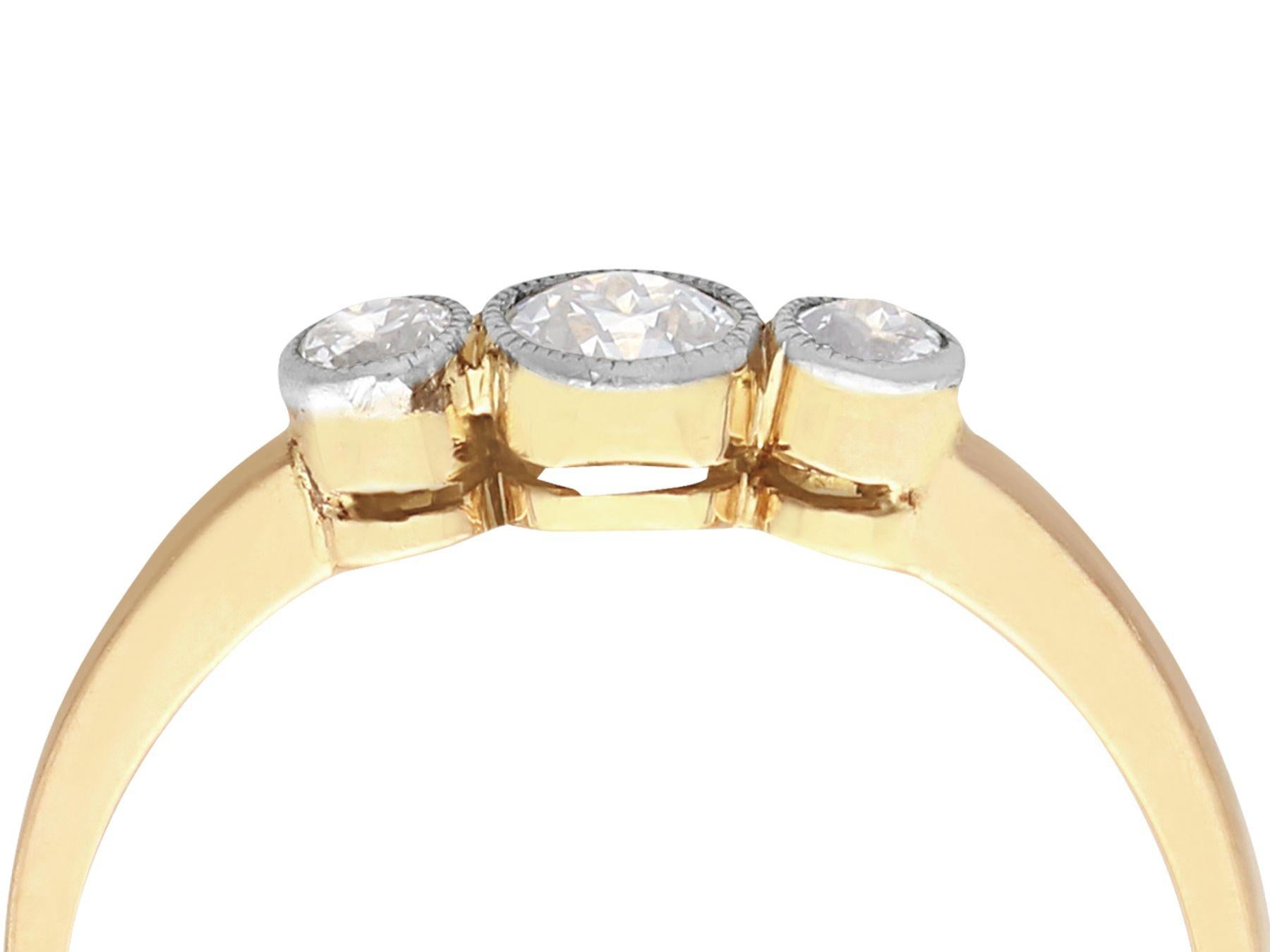 A fine and impressive antique 0.40 carat diamond and 18 karat yellow gold, 18 karat white gold set three stone/trilogy ring; part of our diverse antique diamond jewelry and estate jewelry collections.

This impressive antique three stone diamond