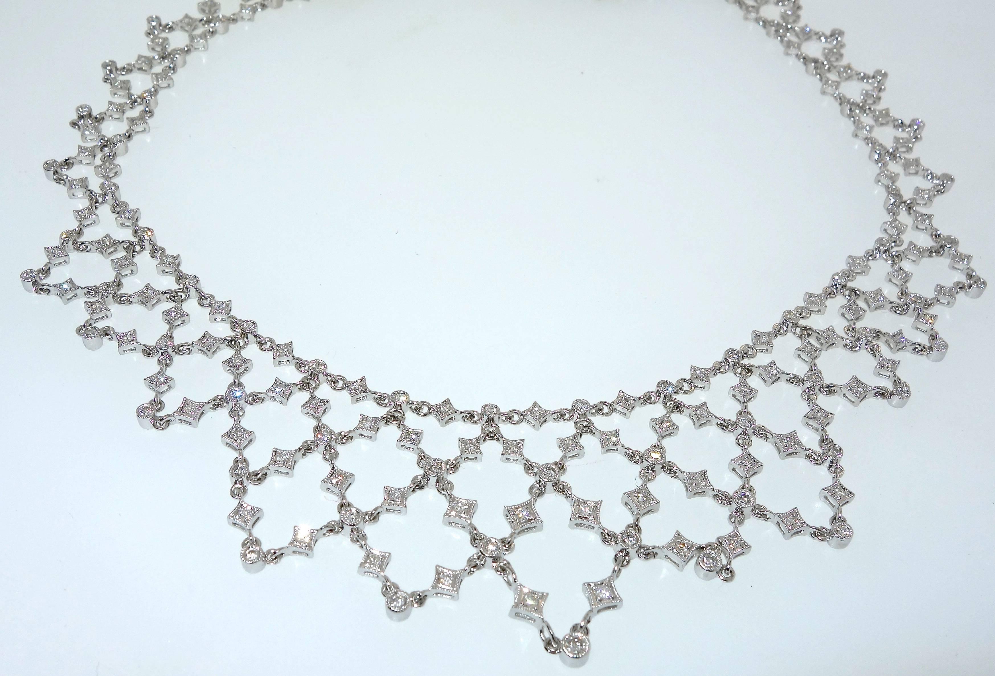 Diamonds are all well cut and well matched, they are all near colorless (H) and very slightly included (VS).  There is approximately 5.88 cts. of diamonds hand set in this elaborate yet delicate 17 inch necklace. 