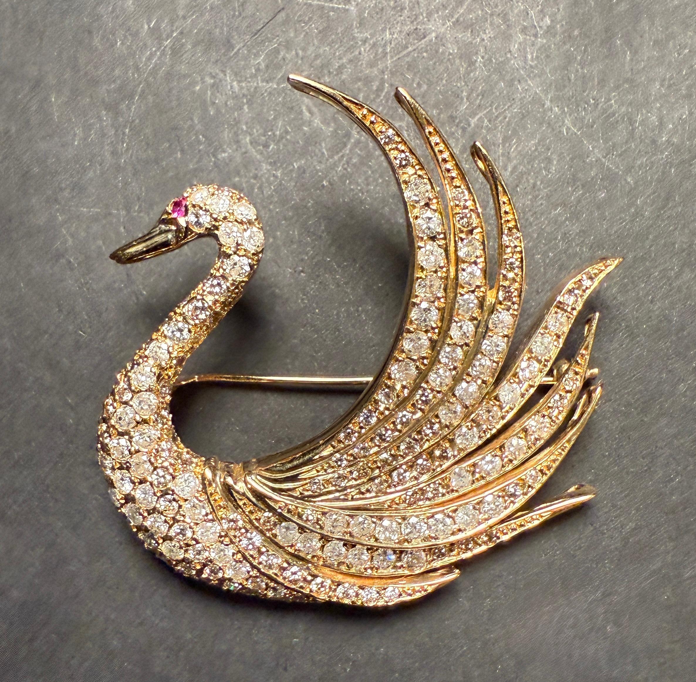 This is a vintage piece from the post-1980s era, meticulously designed as an exquisite swan. The brooch features diamonds weighing about 4.0 carats in total and a round-cut ruby eye all mounted in 18k yellow gold. The contrast between the gold and