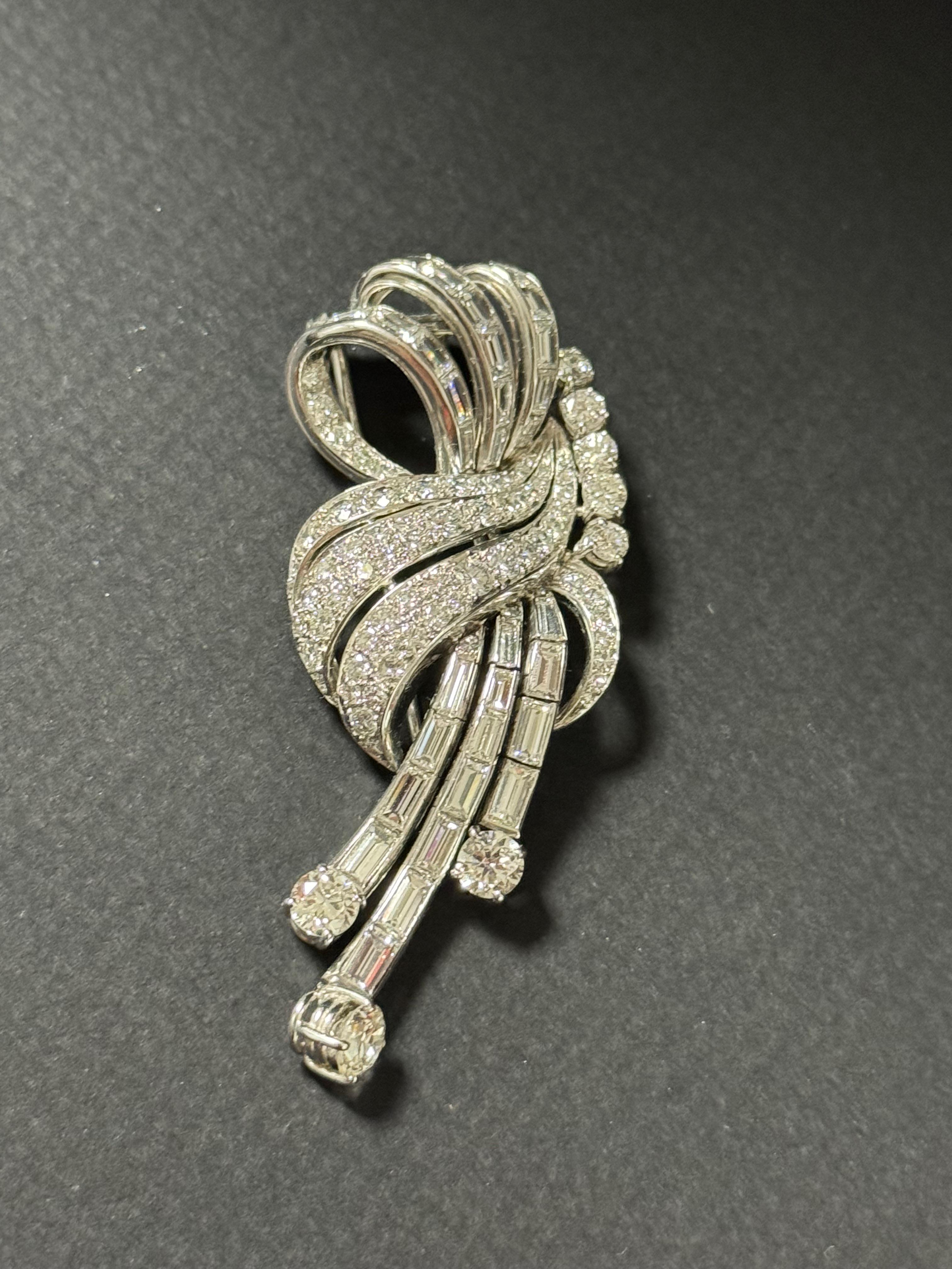 Diamond and 18k White Gold Brooch from circa 1930-50s. 
There are 108 diamonds, 59 brilliant cut diamonds, 30 baguettes diamonds and 19 8/8 diamonds. The weight is circa 9.5 carats in total.
Total weight is 26.66 g ( see picture attached) and is