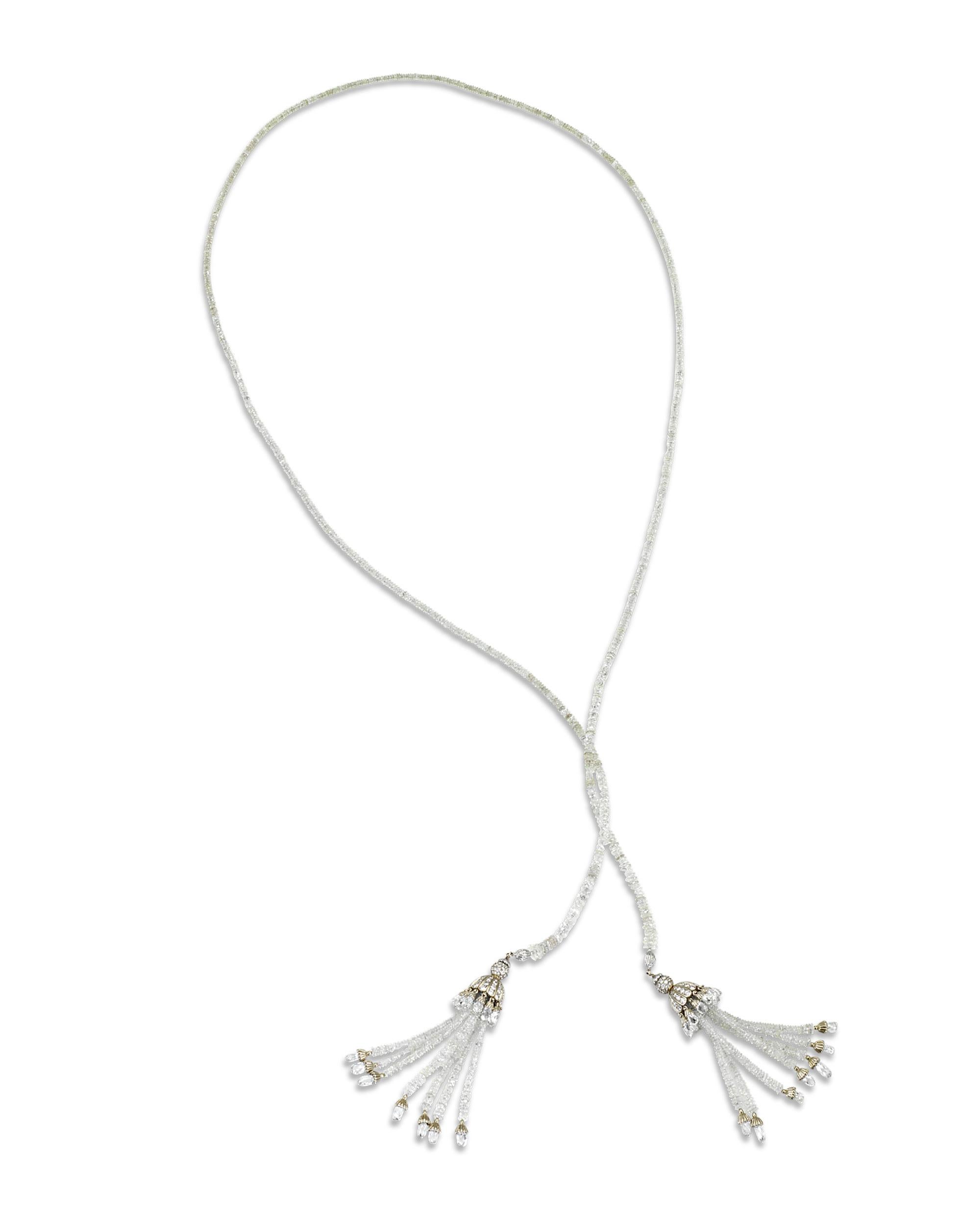Featuring brilliant beads comprised entirely of white diamonds, this stunning necklace features a pair of exotic tassels as its centerpiece pendant. The tassels boast gorgeous briolette-cut white diamonds dangling from the fringe of each tassel. The