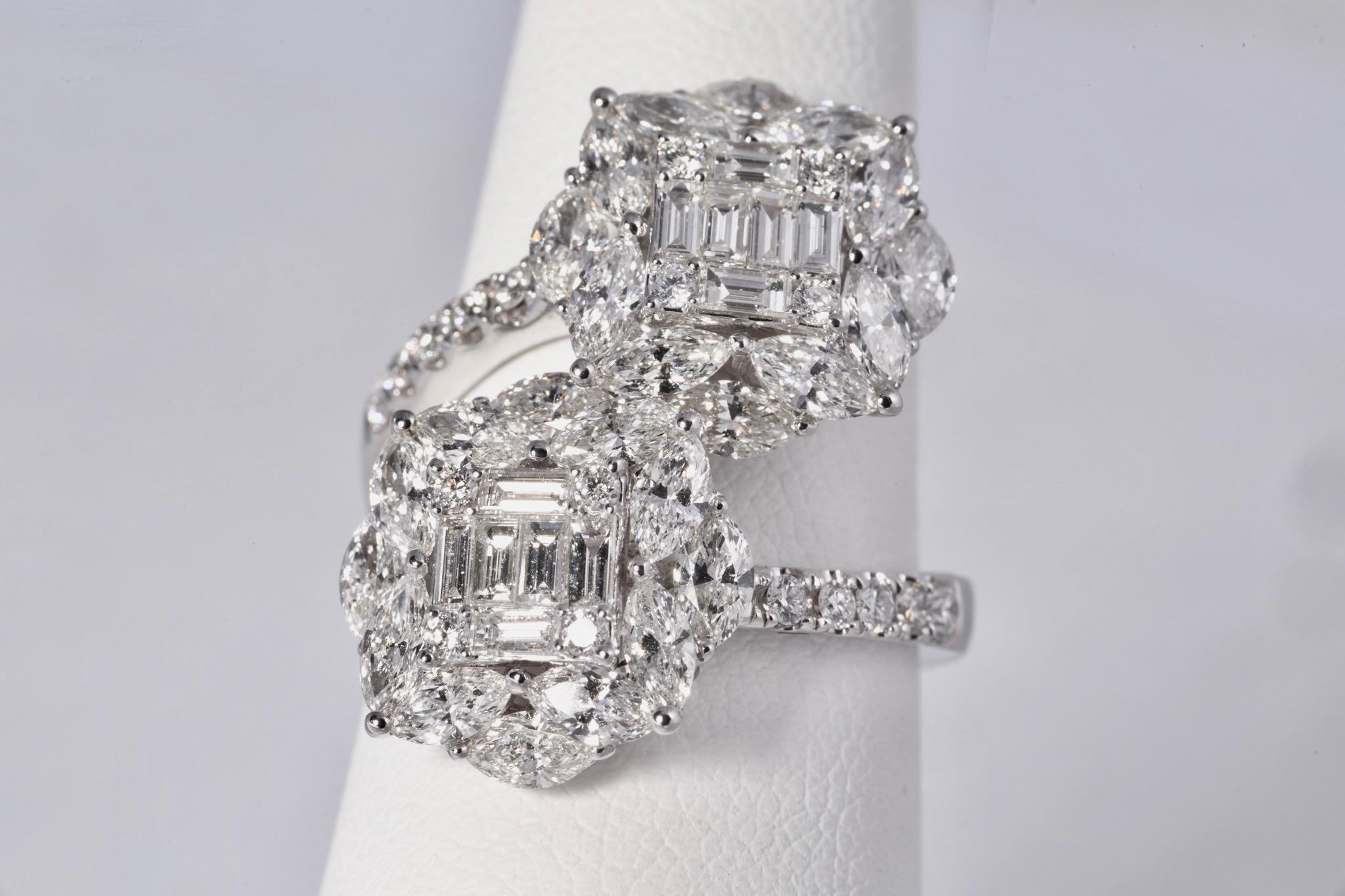 Fabulous diamond cocktail ring with 24 marquise diamonds weighing 2.35cts, 12 baguette cut diamonds weighing .50cts and 18 round cut diamonds weighing .32cts. All diamonds are E-F color and VS clarity. The mounting is 18k white gold. 3.17ct total