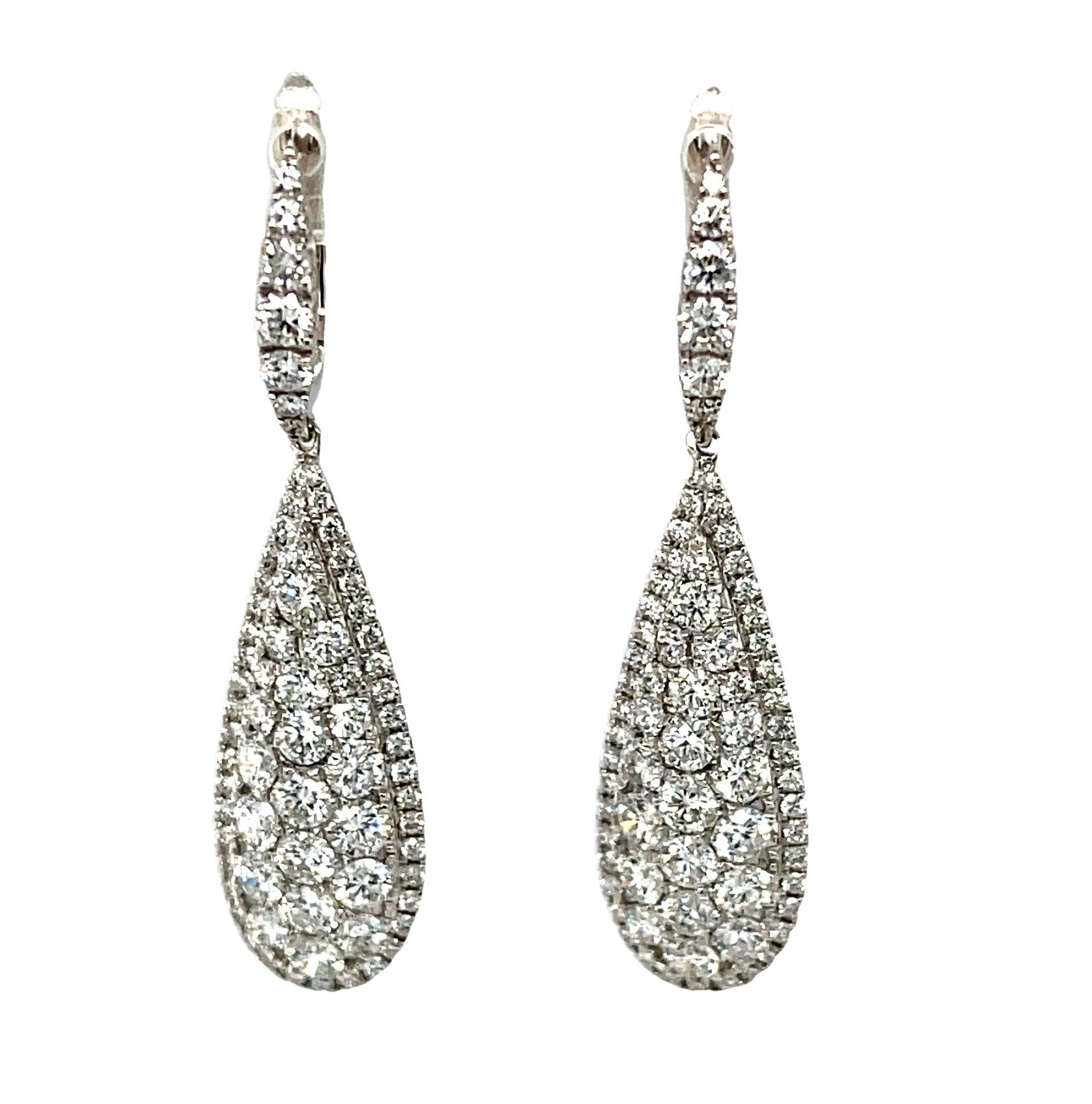 These elegant diamond and white gold dangle earrings are a beautiful way to start, or add to, a fine jewelry wardrobe. They are perfect for a wedding day as well as a lifetime of special events. Sparkling round brilliant diamonds are pave-set in 18k