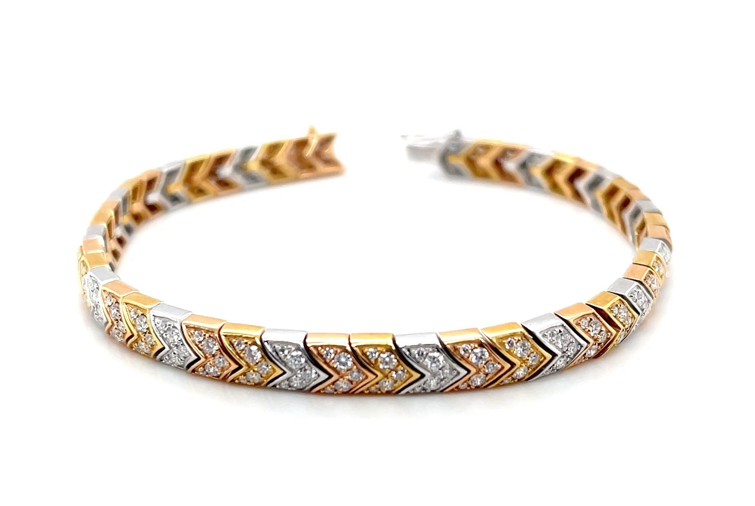 This gorgeous bracelet features 2.43 carats of brilliant natural diamonds beautifully arranged in a stunning line of 18k white, yellow and rose gold links. The chevron shaped links, each masterfully crafted and hand-set with fine white diamonds