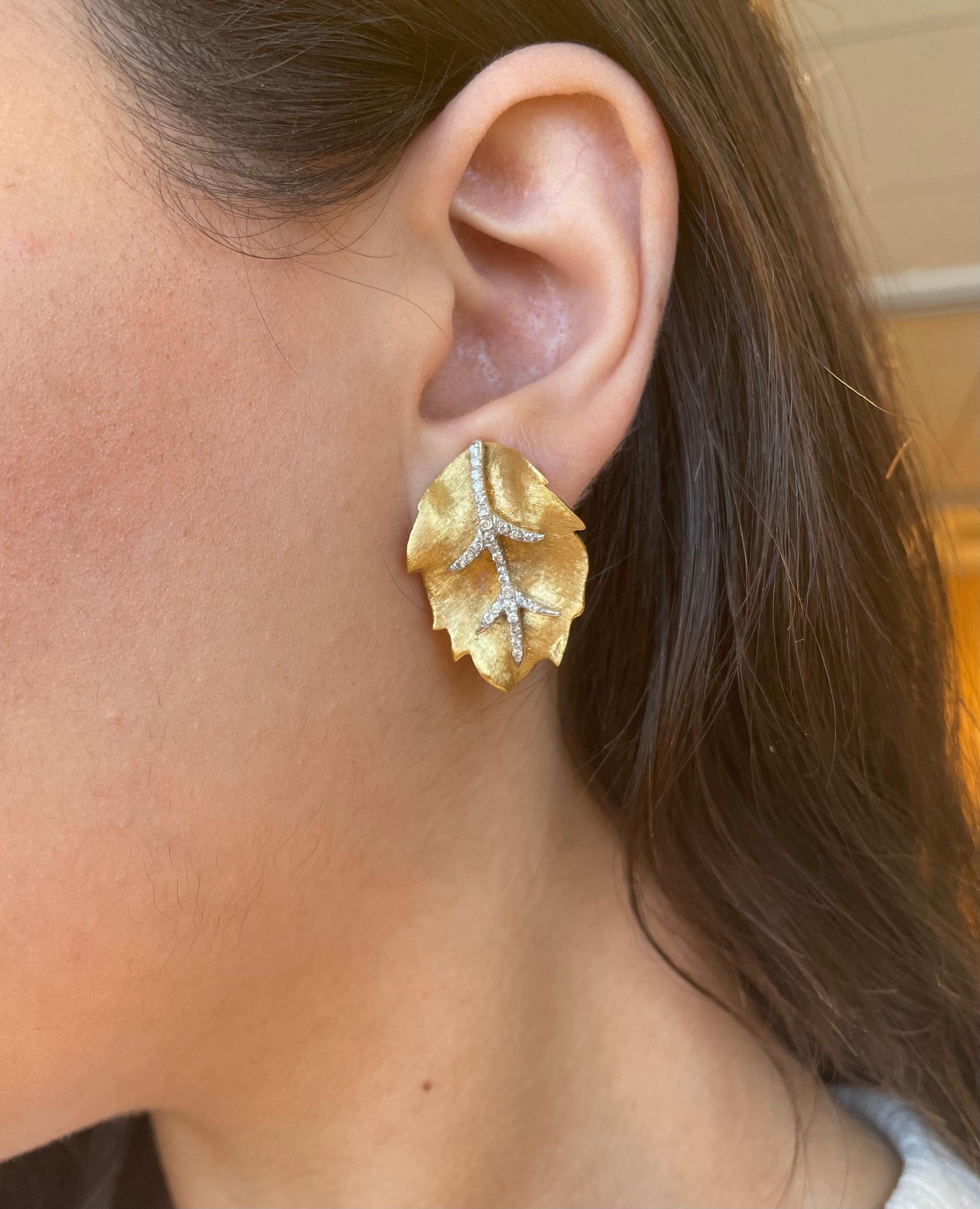 Lovely leaf motif diamond and two tone gold earrings, hand made.
56 round brilliant diamonds approximately 0.70 carats total, H/I color and SI clarity. 18k yellow & white gold.
Accommodated with an up-to-date digital appraisal by a GIA G.G. once