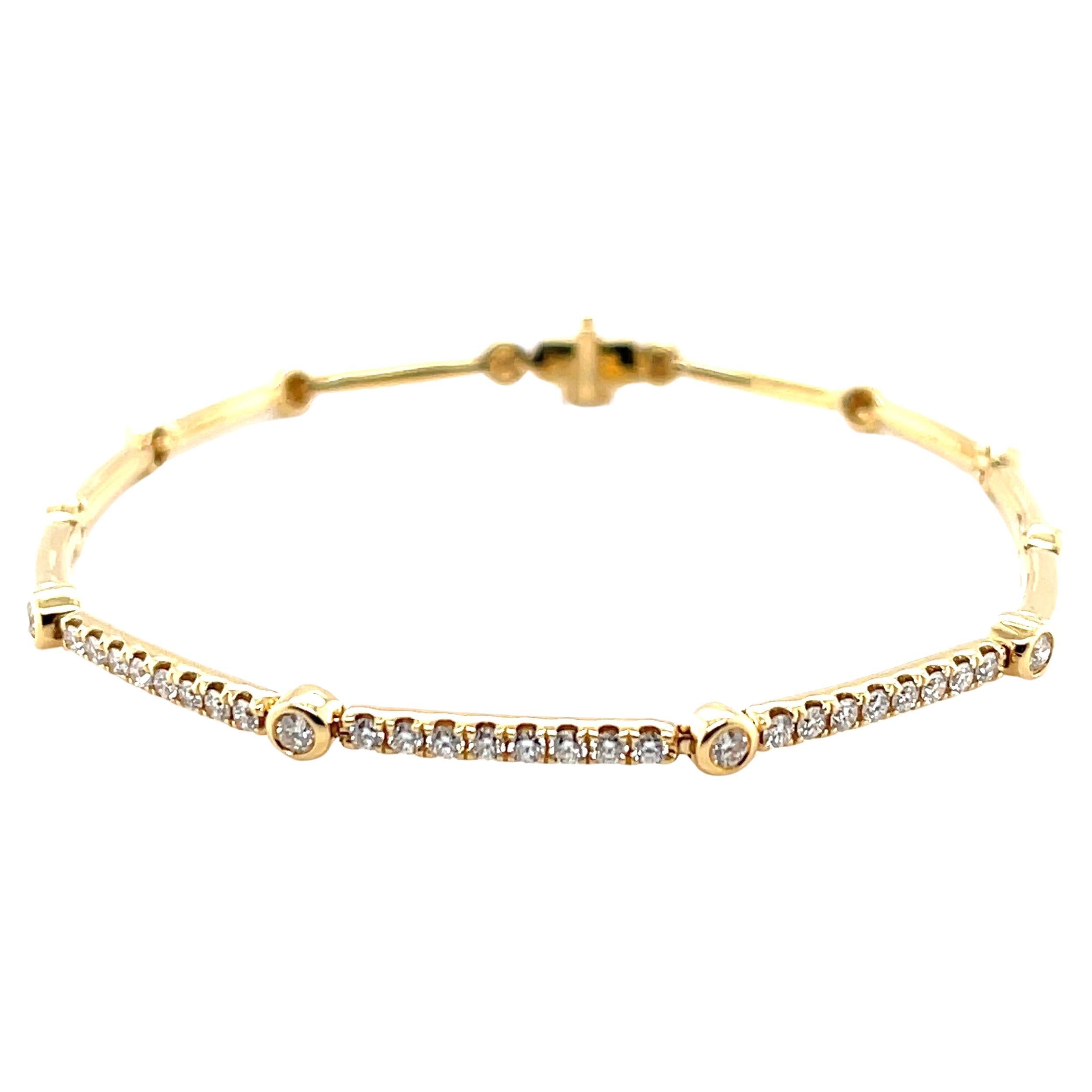This beautifully elegant everyday bracelet has over a half carat of sparking diamonds set in 18k yellow gold! The unique 