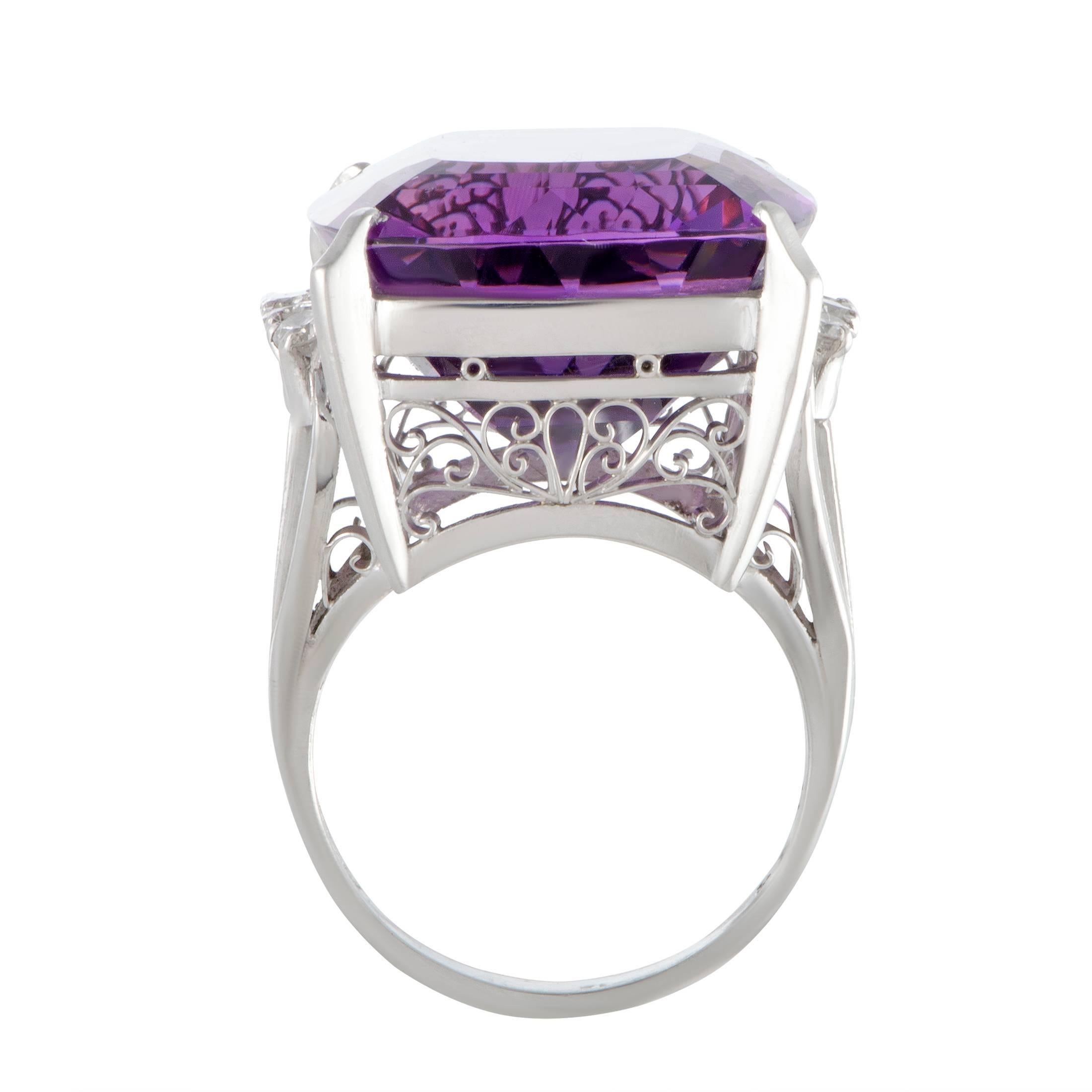 Masterfully crafted in a stunningly intricate manner and lavishly set with eye-catching gems, this fabulous ring features compelling design and luxurious décor. The ring is made of platinum and boasts a spellbinding amethyst and 0.35 carats of