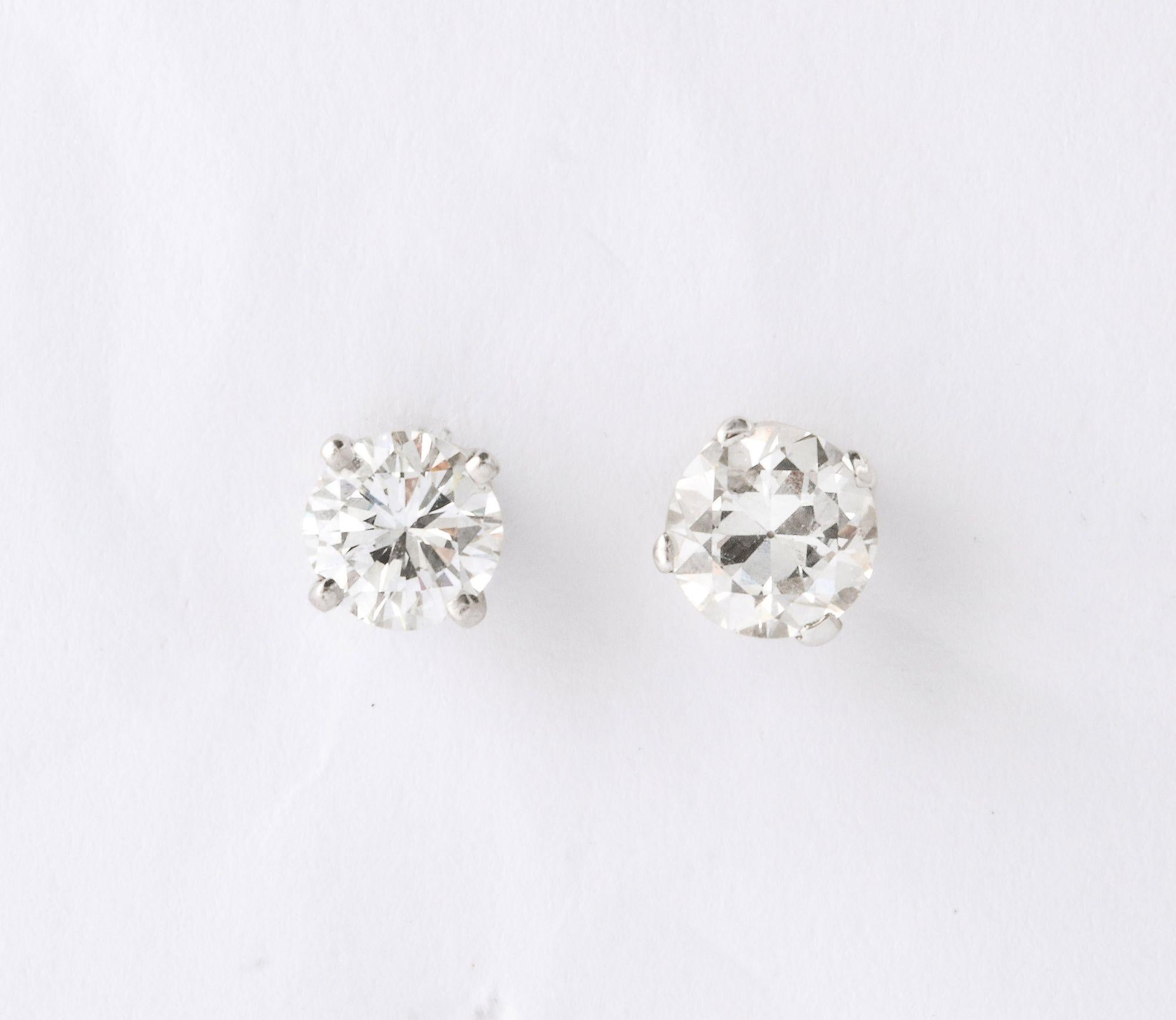 A classic pair of diamond studs .25 each with carved floral black coral jackets