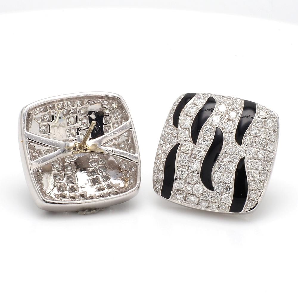 Earrings with Round Cut Diamonds and Enamel Detailing

These elegant earrings showcase round cut diamonds, beautifully set against a striking enamel backdrop. Weighing 11.4 grams, they offer a sophisticated and eye-catching addition to any jewelry