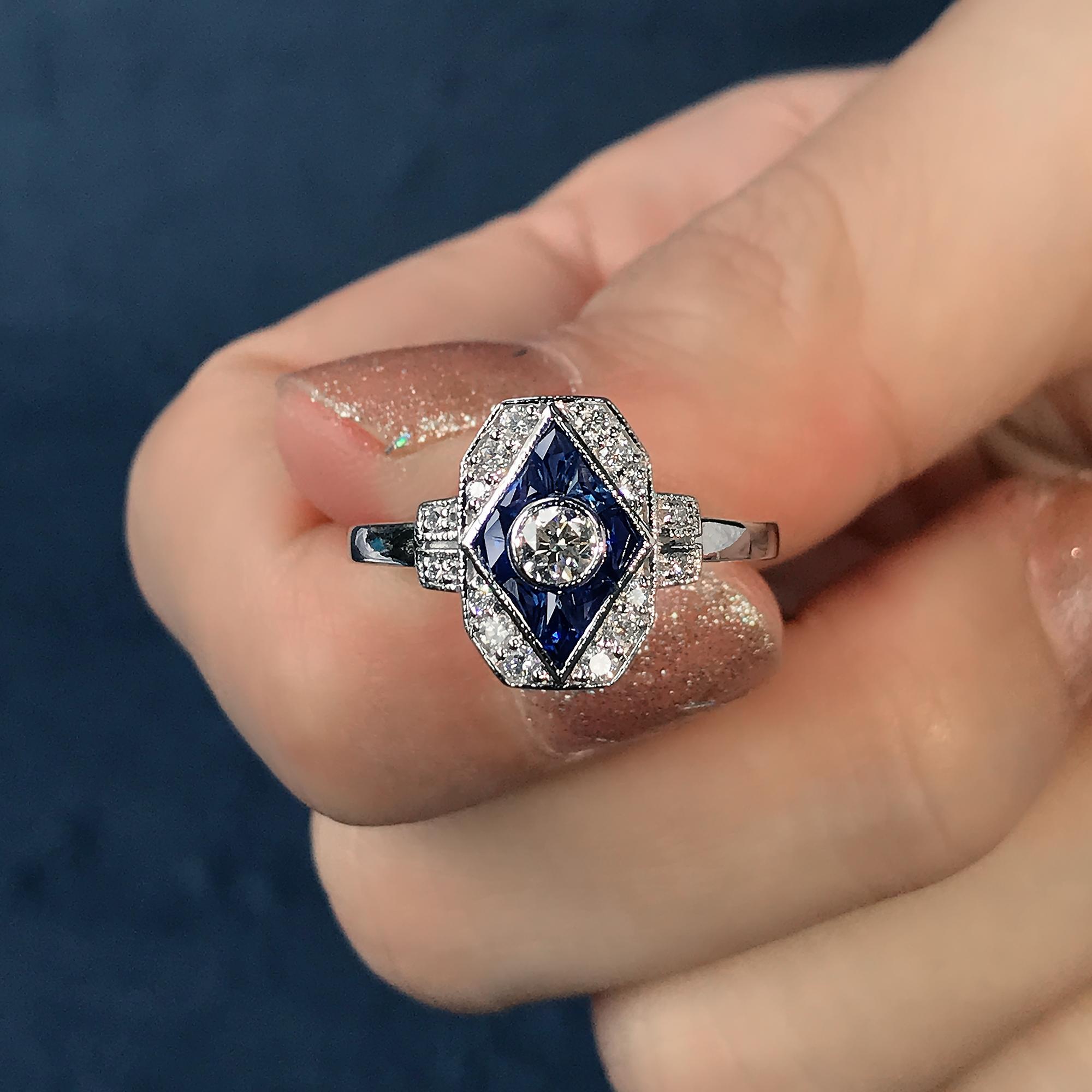 This beautiful ring is a vintage inspired style, the halo ring features round H color SI clarity diamond for its center, surrounded by French cut blue sapphire and round diamonds. This would make a wonderful engagement ring, or to commemorate an